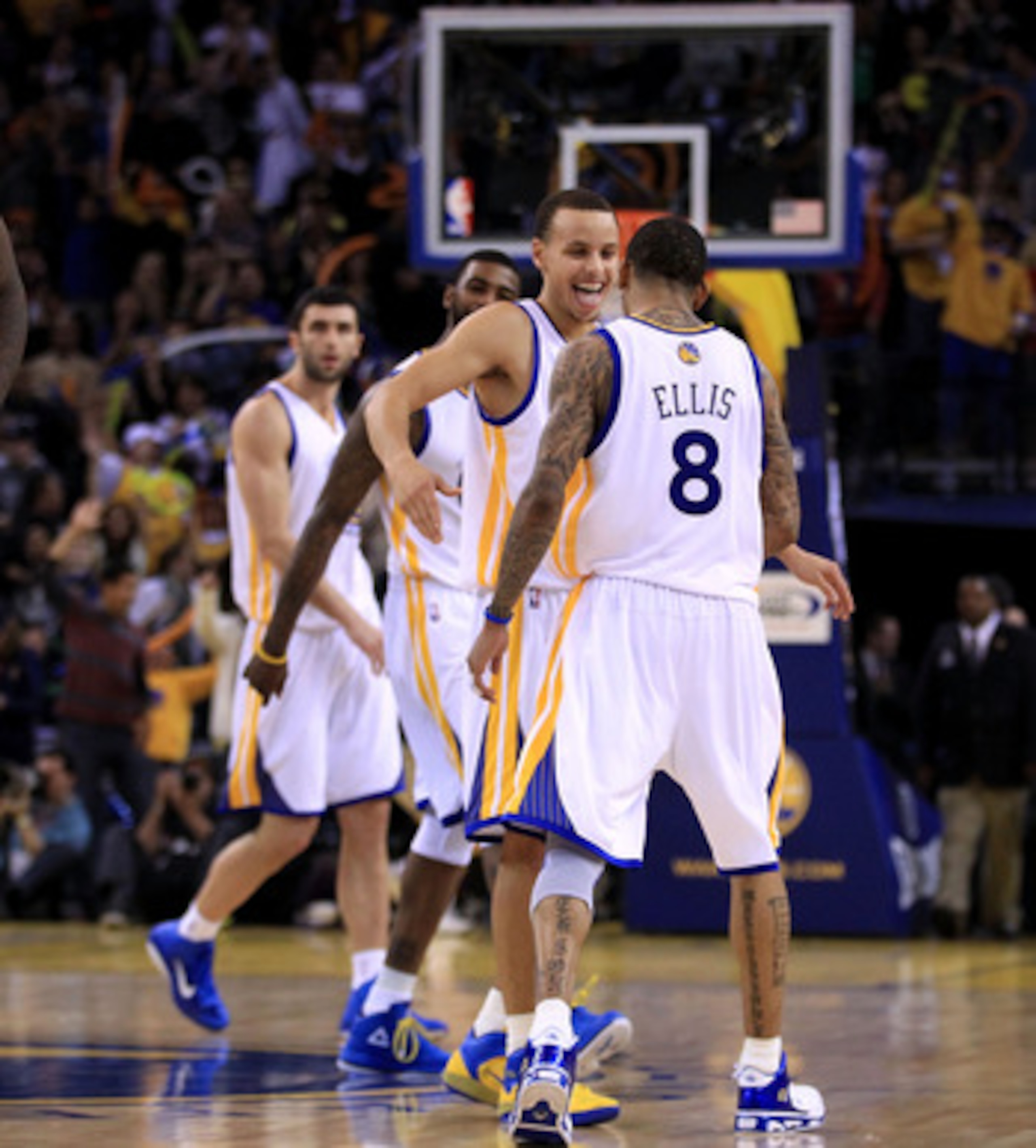 OAKLAND, CA - JANUARY 21:  Monta Ellis #8 is congratulated by Stephen Curry #30 of the Golden State Warriors after Ellis made a shot with less than a second left in regulation to send their game against the Sacramento Kings into overtime at Oracle Arena o