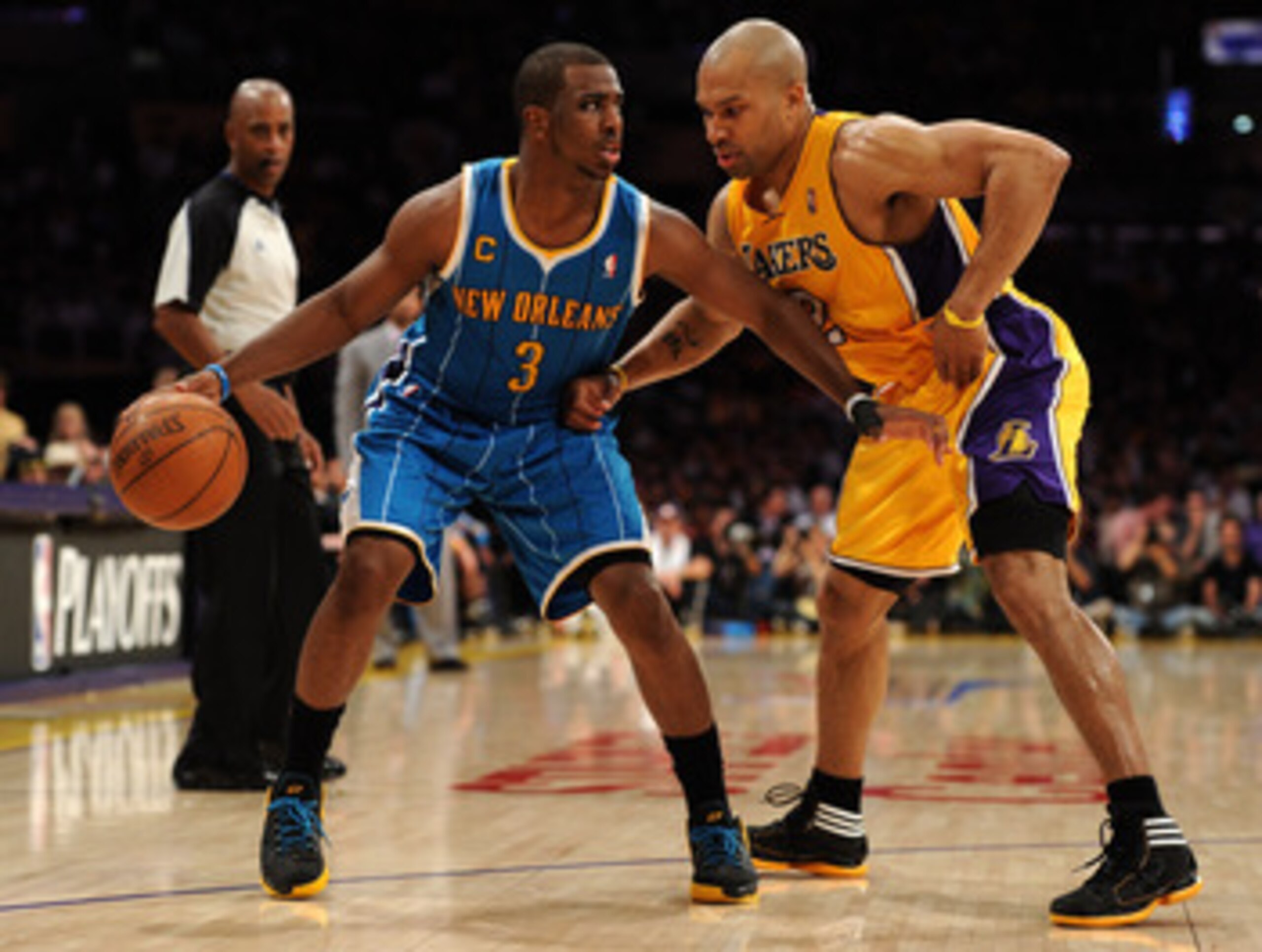 LOS ANGELES, CA - APRIL 26:  Chris Paul #3 of the New Orleans Hornets moves the ball against Derek Fisher #2 of the Los Angeles Lakers in Game Five of the Western Conference Quarterfinals in the 2011 NBA Playoffs on April 26, 2011 at Staples Center in Los