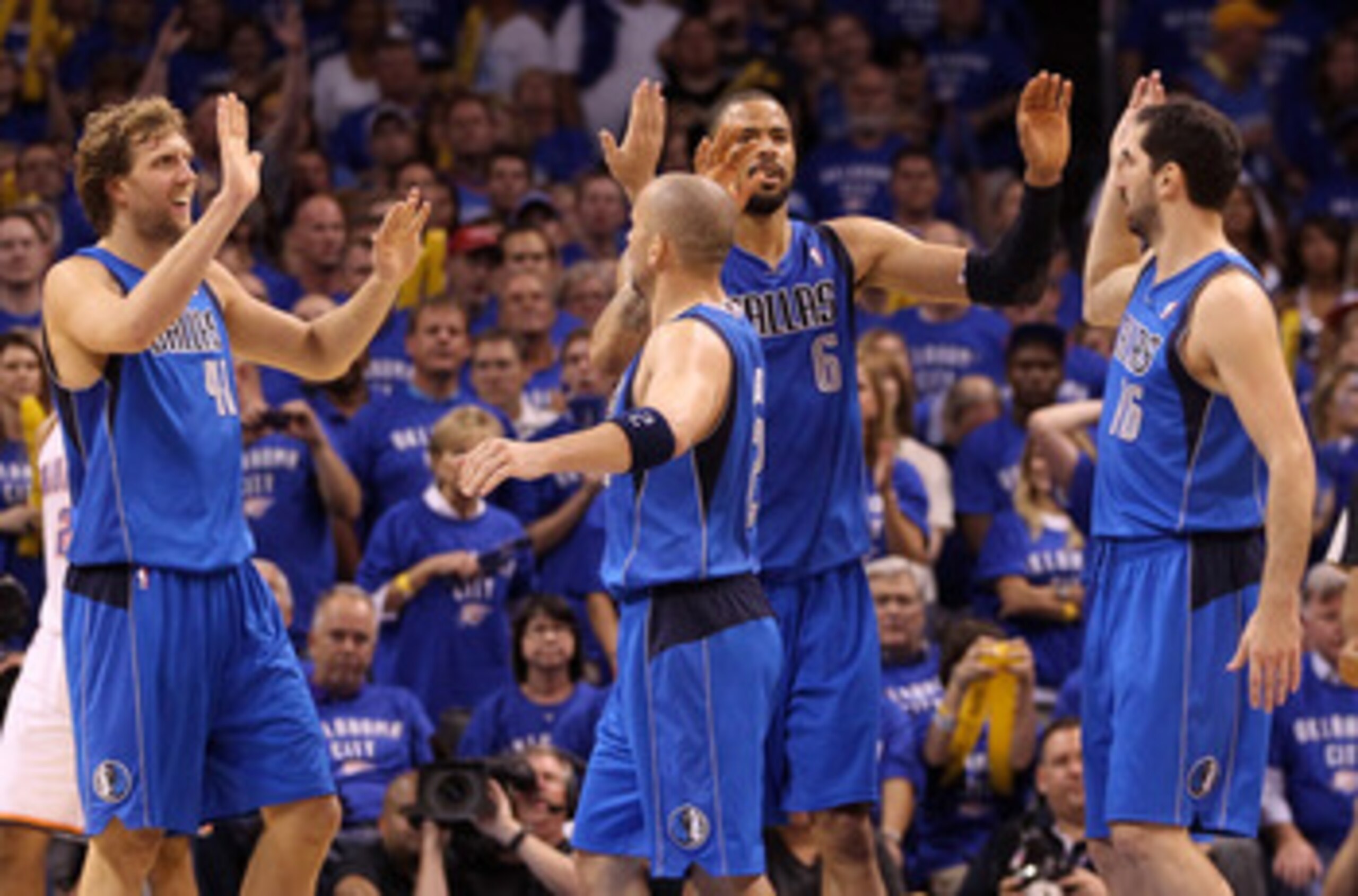 OKLAHOMA CITY, OK - MAY 23:  (L-R) Dirk Nowitzki #41, Jason Kidd #2, Tyson Chandler #6 and Peja Stojakovic #16 of the Dallas Mavericks react in the fourth quarter while taking on the Oklahoma City Thunder in Game Four of the Western Conference Finals duri