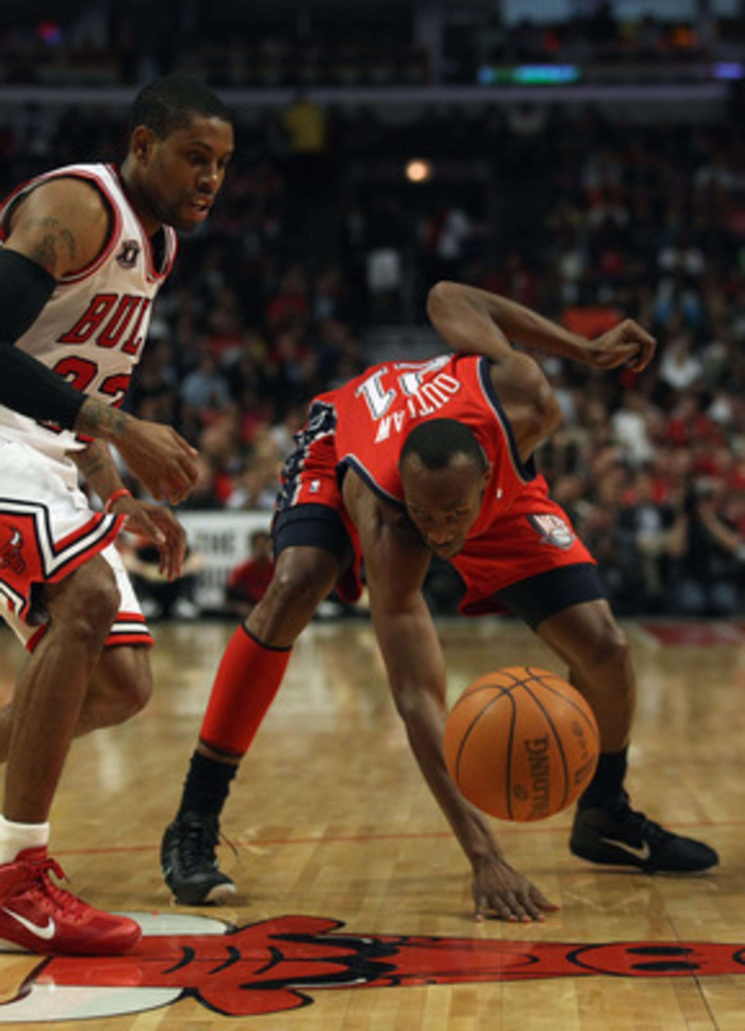 CHICAGO, IL - APRIL 13: Travis Outlaw #21 of the New Jersey Nets looses control of the ball as C.J. Watson #32 of the Chicago Bulls defends at the United Center on April 13, 2011 in Chicago, Illinois. NOTE TO USER: User expressly acknowledges and agrees t