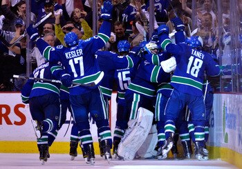 VANCOUVER, CANADA - MAY 24:  Mason Raymond #21, Ryan Kesler #17, Tanner Glass #15, goaltender Roberto Luongo #1 and Chris Tanev #18 of the Vancouver Canucks and their teammates celebrate after they defeated the San Jose Sharks 3-2 in double-overtime in Ga