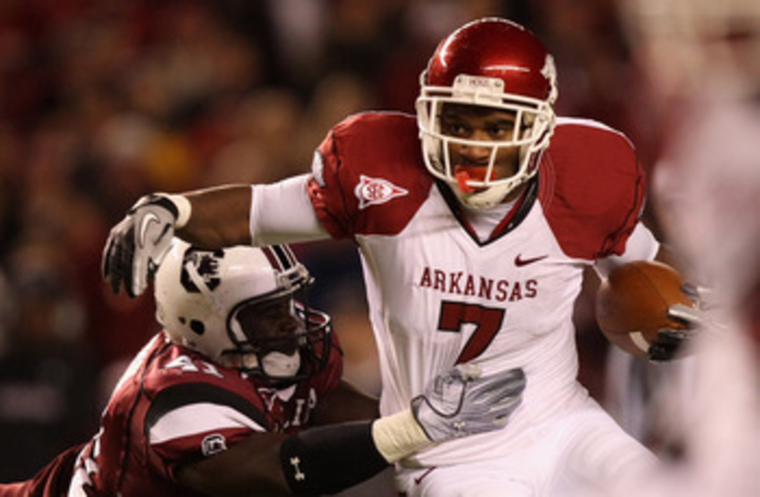 COLUMBIA, SC - NOVEMBER 06:  Knile Davis #7 of the Arkansas Razorbacks pushes away from Josh Dickerson #41 of the South Carolina Gamecocks during their game at Williams-Brice Stadium on November 6, 2010 in Columbia, South Carolina.  (Photo by Streeter Lec