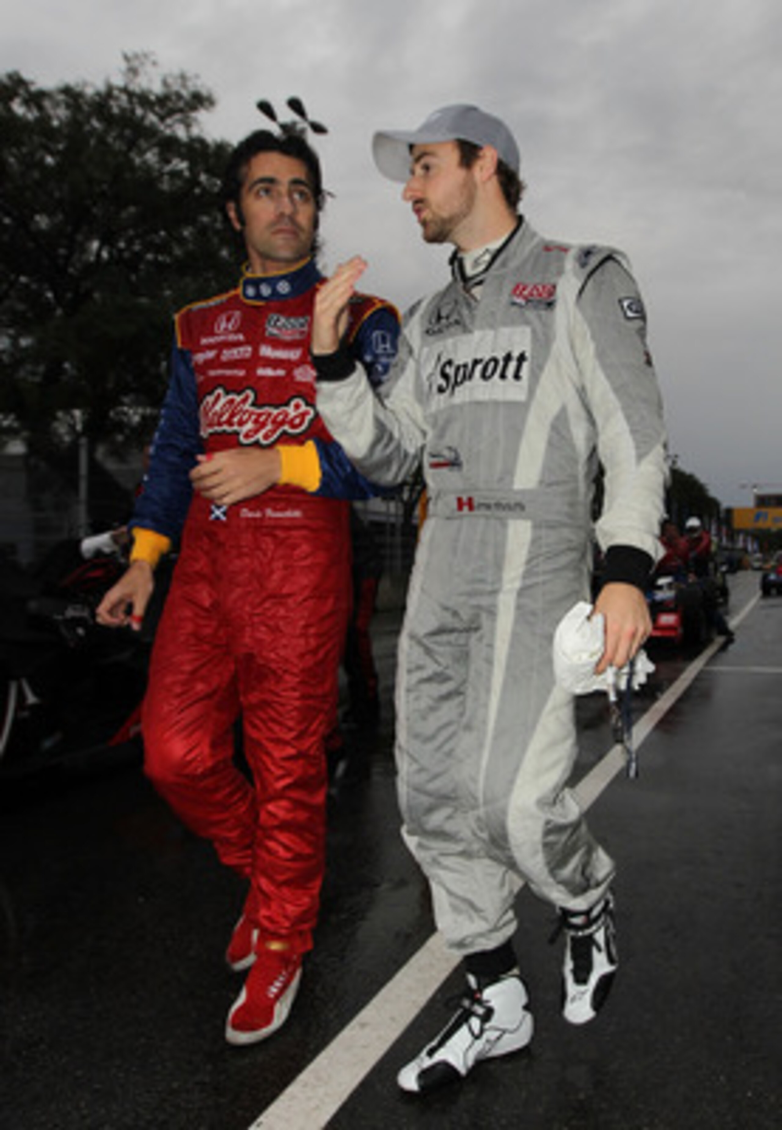 SAO PAULO, BRAZIL - MAY 01:  (L-R) Dario Franchitti of Scotland driver of the #10 Target Chip Ganassi Racing Kellogg's Dallara Honda and James Hinchcliffe of Canada driver of the Sprott Newman/Haas Racing Dallara Honda walk from pitlane after the race was