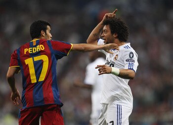 MADRID, SPAIN - APRIL 27:  Marcelo of Real Madrid and Pedro Rodriguez of Barcelona clash during the UEFA Champions League Semi Final first leg match between Real Madrid and Barcelona at Estadio Santiago Bernabeu on April 27, 2011 in Madrid, Spain.  (Photo