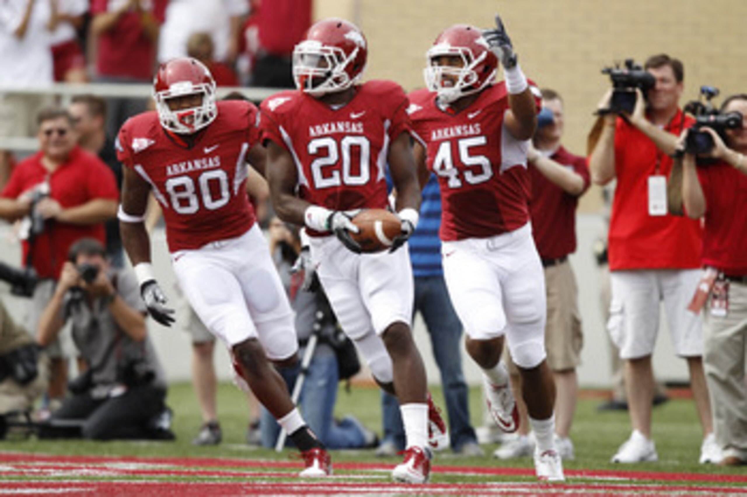 FAYETTEVILLE - SEPTEMBER 25: Ronnie Wingo Jr. #20 of the Arkansas Razorbacks celebrates with teammates D.J. Williams #45 and Chris Gragg #80 after a first half touchdown against the Alabama Crimson Tide at Donald W. Reynolds Razorback Stadium on September