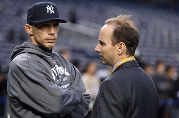 NEW YORK - OCTOBER 28:  Manager Joe Girardi (L) and General Manager Brian Cashman of the New York Yankees look on during batting practice against the Philadelphia Phillies in Game One of the 2009 MLB World Series at Yankee Stadium on October 28, 2009 in t
