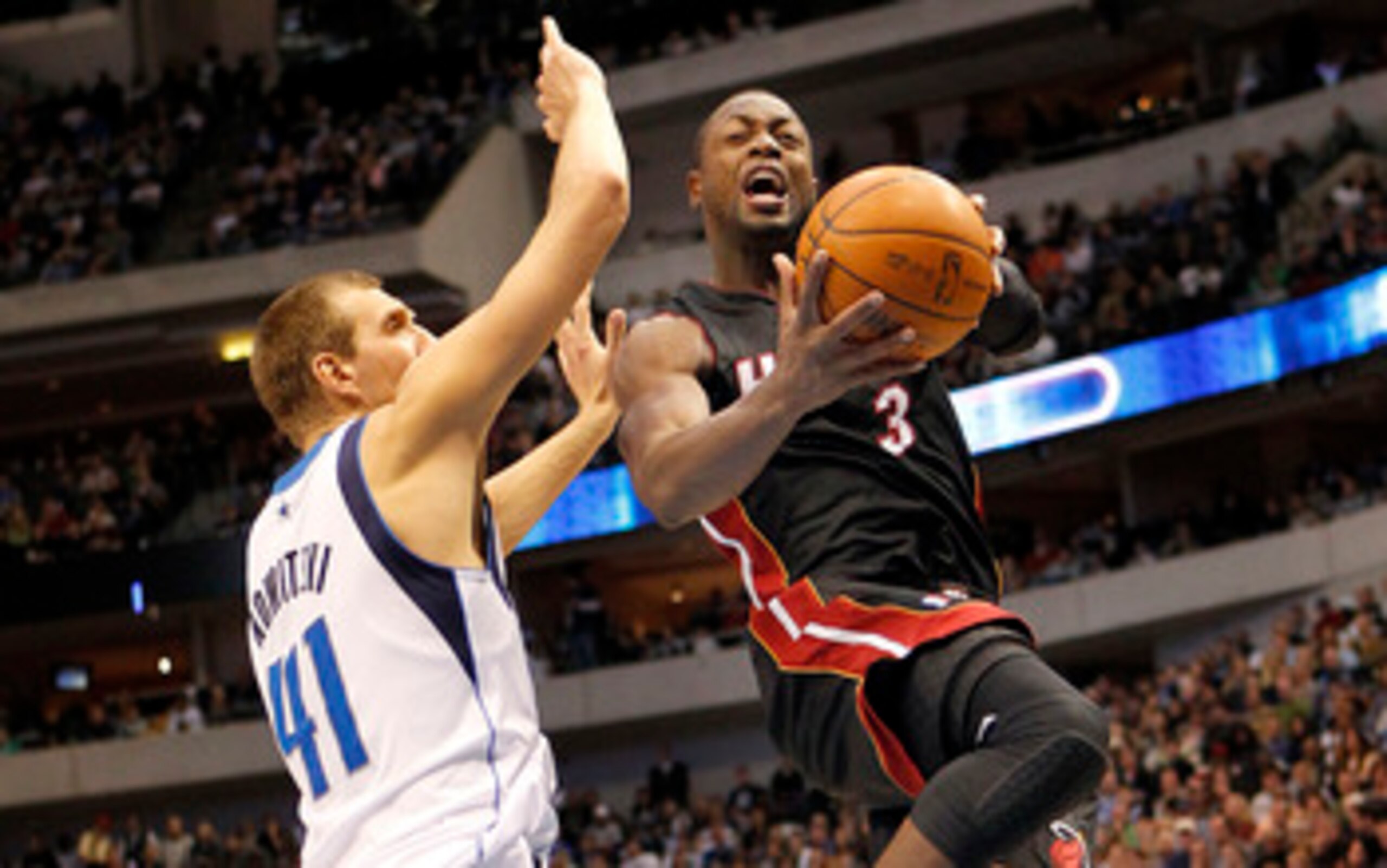 DALLAS - NOVEMBER 27: Dwyane Wade #3 of the Miami Heat drives by Dirk Nowitzki #41 of the Dallas Mavericks on November 27, 2010 at the American Airlines Center in Dallas, Texas. NOTE TO USER: User expressly acknowledges and agrees that, by downloading and