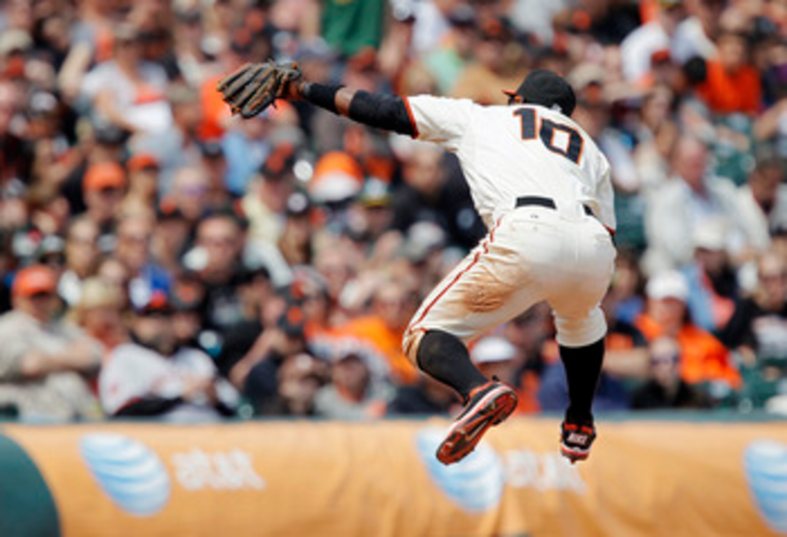 SAN FRANCISCO, CA - MAY 22: Miguel Tejada #10 of the San Francisco Giants leaps to catch a line-drive from Conor Jackson of the Oakland A's in the sixth inning at AT&T Park on May 22, 2011 in San Francisco, California. The Giants won 5-4 in 11 innings. (P