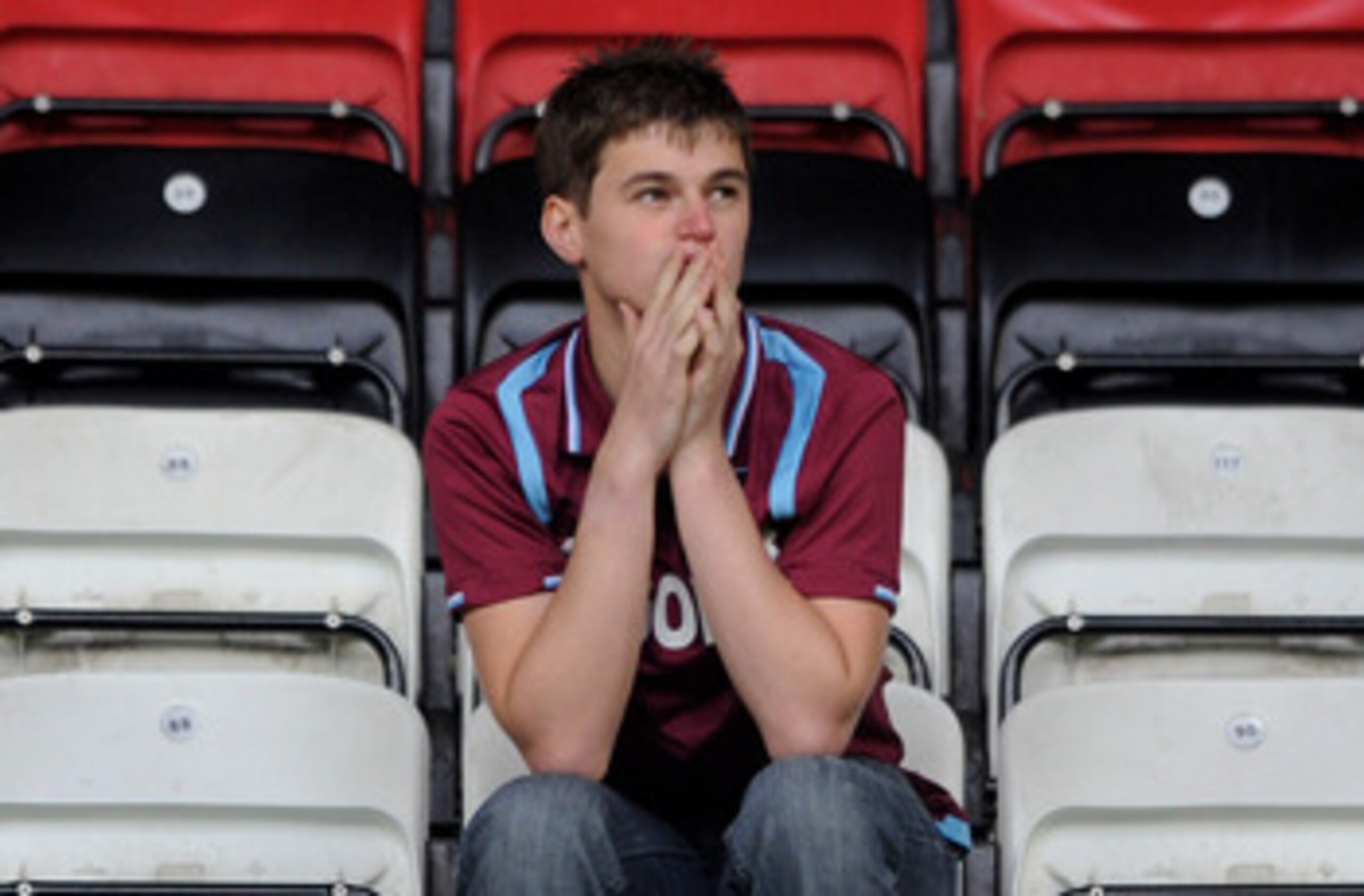 WIGAN, ENGLAND - MAY 15: A West Ham United fan looks dejected following his team's relegation at the end of the Barclays Premier League match between Wigan Athletic and West Ham United at the DW Stadium on May 15, 2011 in Wigan, England. (Photo by Chris WIGAN, ENGLAND - MAY 15: A West Ham United fan looks dejected following his team's relegation at the end of the Barclays Premier League match between Wigan Athletic and West Ham United at the DW Stadium on May 15, 2011 in Wigan, England. (Photo by Chris