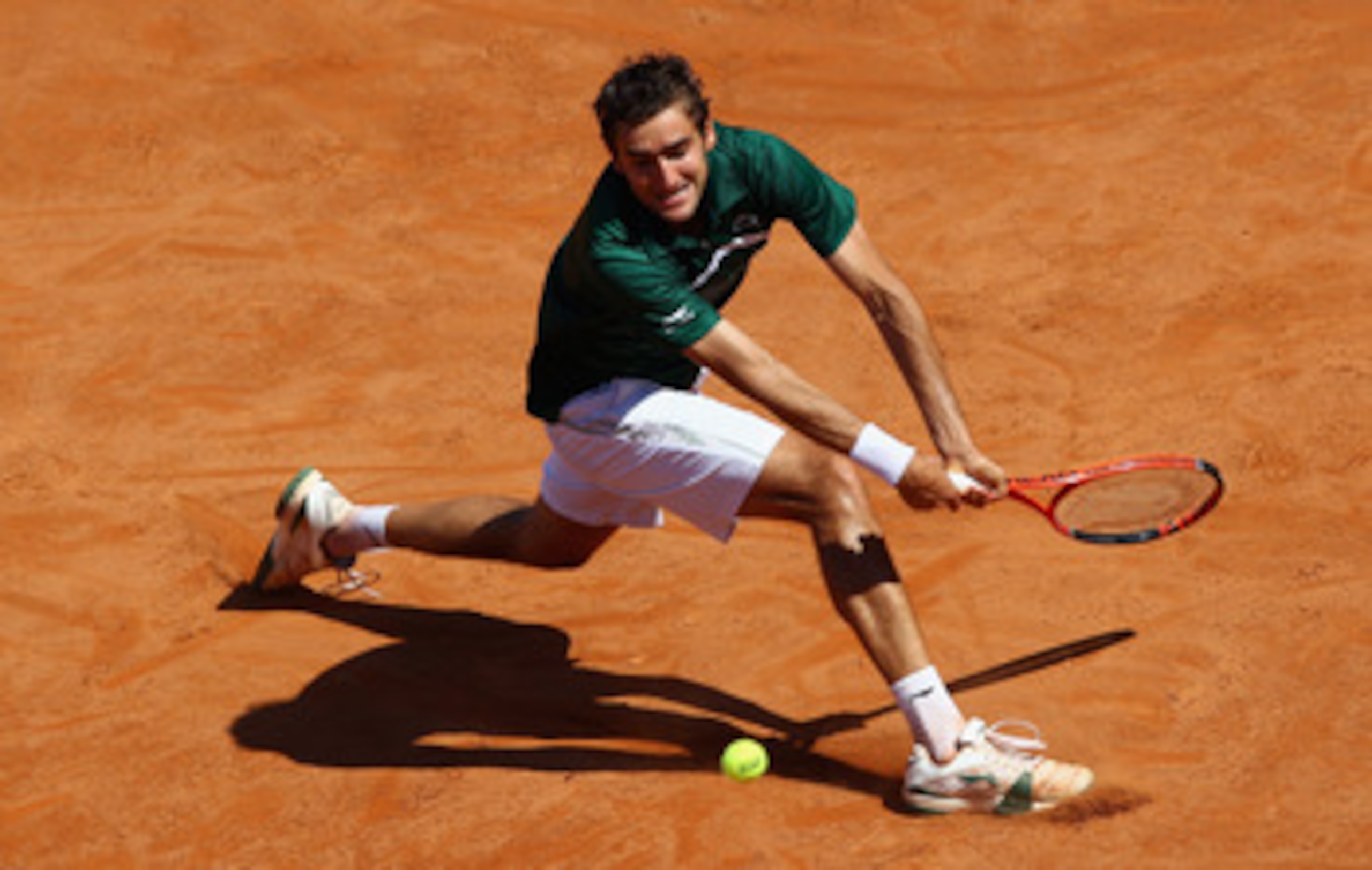 ROME, ITALY - MAY 13:  Marin Cilic of Croatia slides to play a backhand during his quarter final match against Rafael Nadal of Spain during day six of the Internazoinali BNL D'Italia at the Foro Italico Tennis Centre  on May 13, 2011 in Rome, Italy.  (Pho