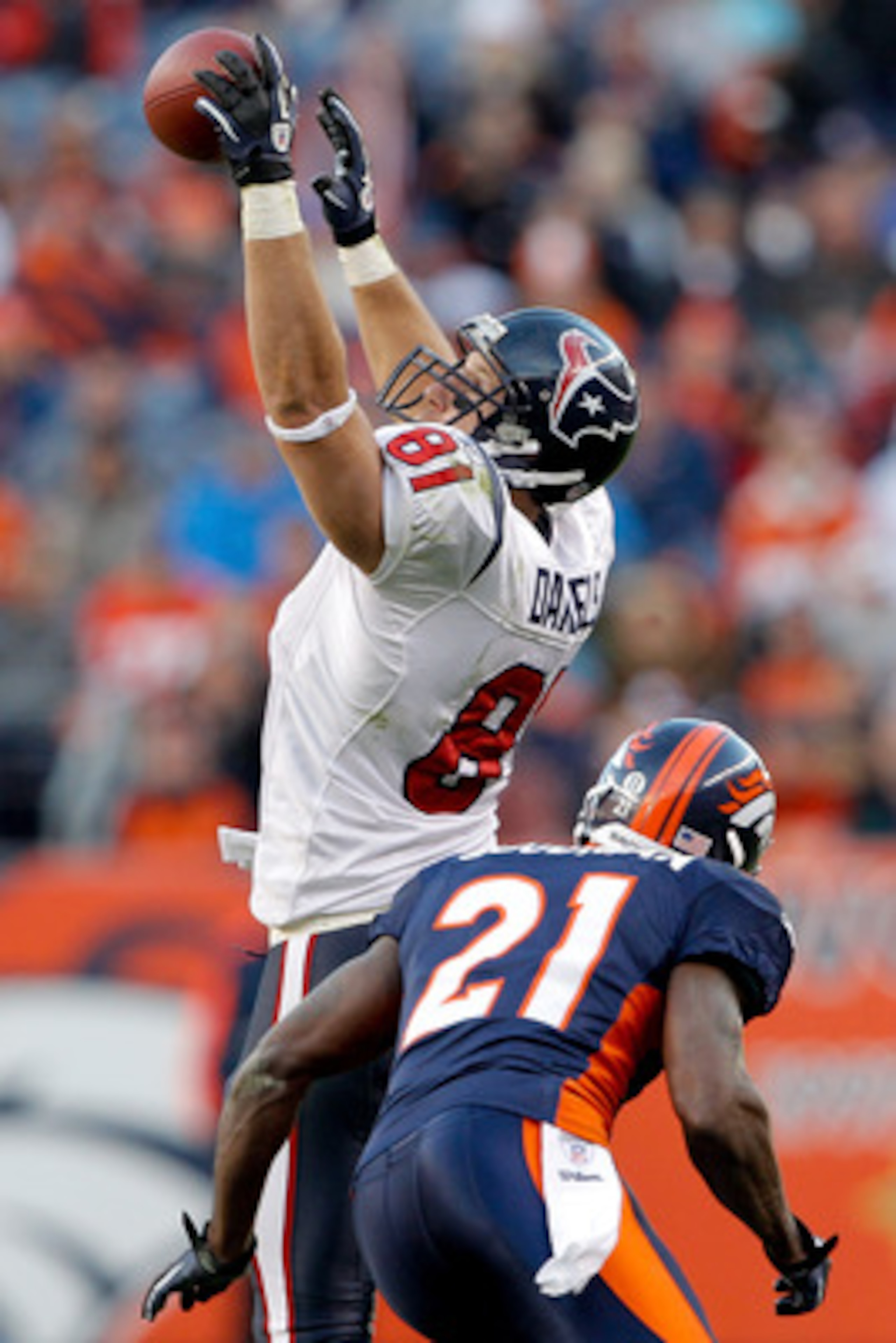 DENVER - DECEMBER 26:  Tight end Owen Daniels #81 of the Houston Texans makes a one-handed catch against cornerback Andre' Goodman #21 of the Denver Broncos during the third quarter at INVESCO Field at Mile High on December 26, 2010 in Denver, Colorado.  