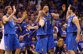 OKLAHOMA CITY, OK - MAY 23:  (L-R) Dirk Nowitzki #41, Jason Kidd #2, Tyson Chandler #6 and Peja Stojakovic #16 of the Dallas Mavericks react in the fourth quarter while taking on the Oklahoma City Thunder in Game Four of the Western Conference Finals duri