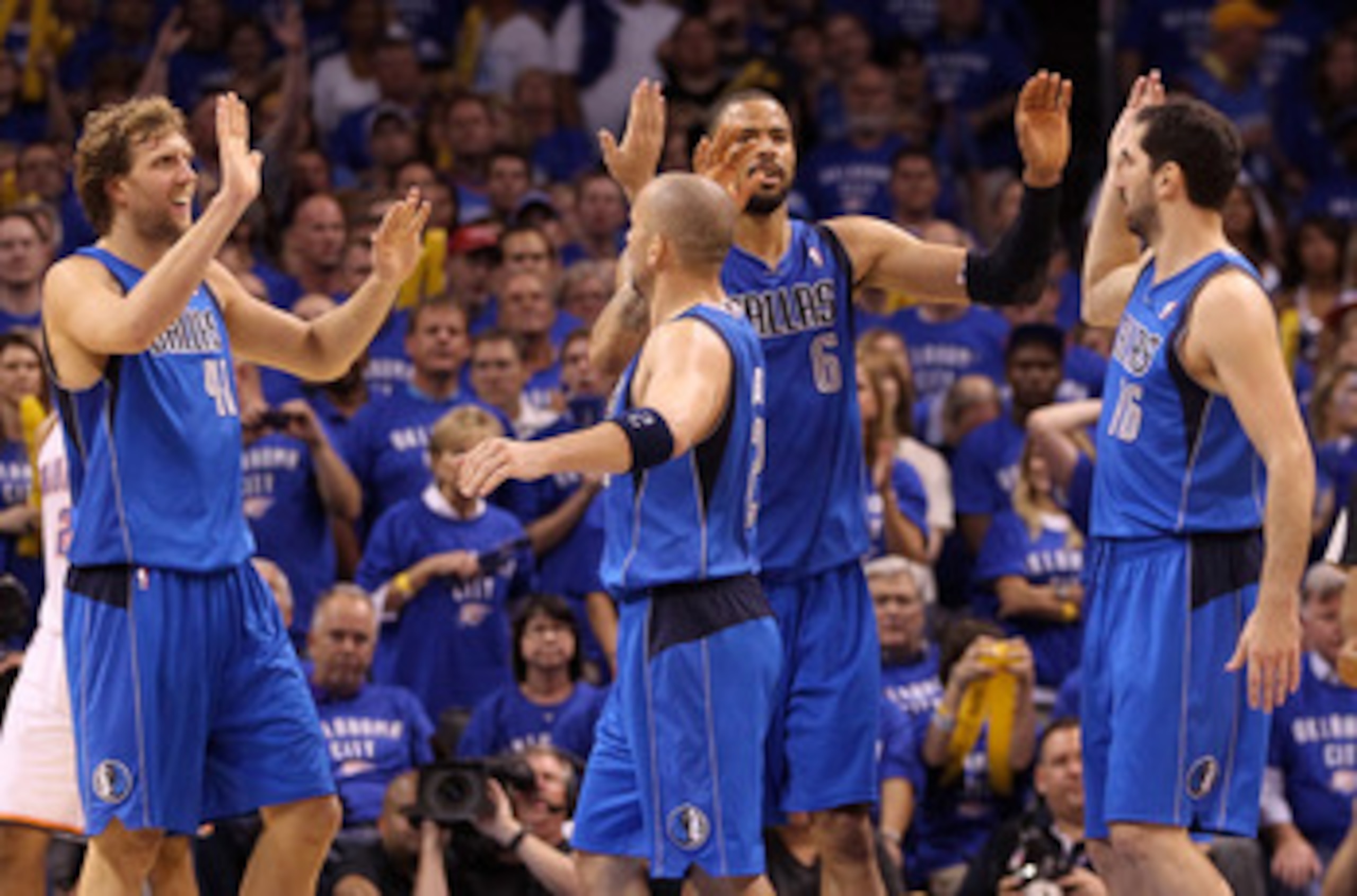 OKLAHOMA CITY, OK - MAY 23:  (L-R) Dirk Nowitzki #41, Jason Kidd #2, Tyson Chandler #6 and Peja Stojakovic #16 of the Dallas Mavericks react in the fourth quarter while taking on the Oklahoma City Thunder in Game Four of the Western Conference Finals duri