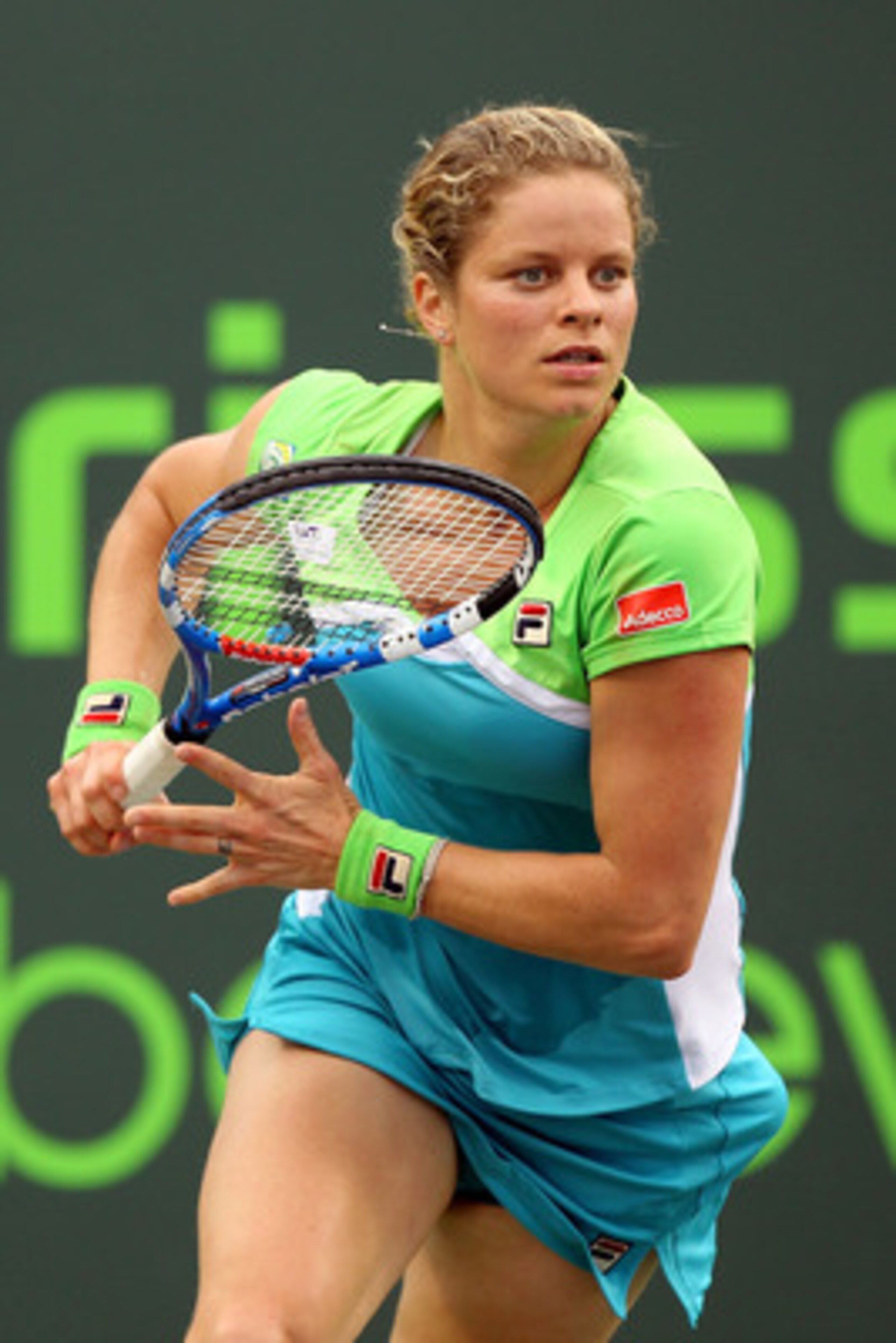 KEY BISCAYNE, FL - MARCH 29:  Kim Clijsters of Belgium runs towards the net against Ana Ivanovic of Serbia during the Sony Ericsson Open at Crandon Park Tennis Center on March 29, 2011 in Key Biscayne, Florida.  (Photo by Al Bello/Getty Images)