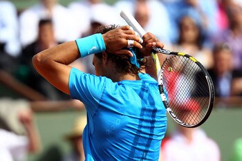 PARIS, FRANCE - MAY 24:  Rafael Nadal of Spain shows his dejection during the men's singles round one match between Rafael Nadal of Spain and John Isner of USA on day three of the French Open at Roland Garros on May 24, 2011 in Paris, France.  (Photo by C