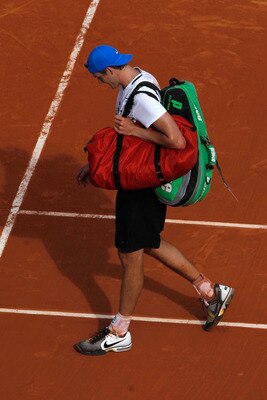PARIS, FRANCE - MAY 24:  John Isner of USA shows his dejection as he walks off court following the men's singles round one match between Rafael Nadal of Spain and John Isner of USA on day three of the French Open at Roland Garros on May 24, 2011 in Paris,