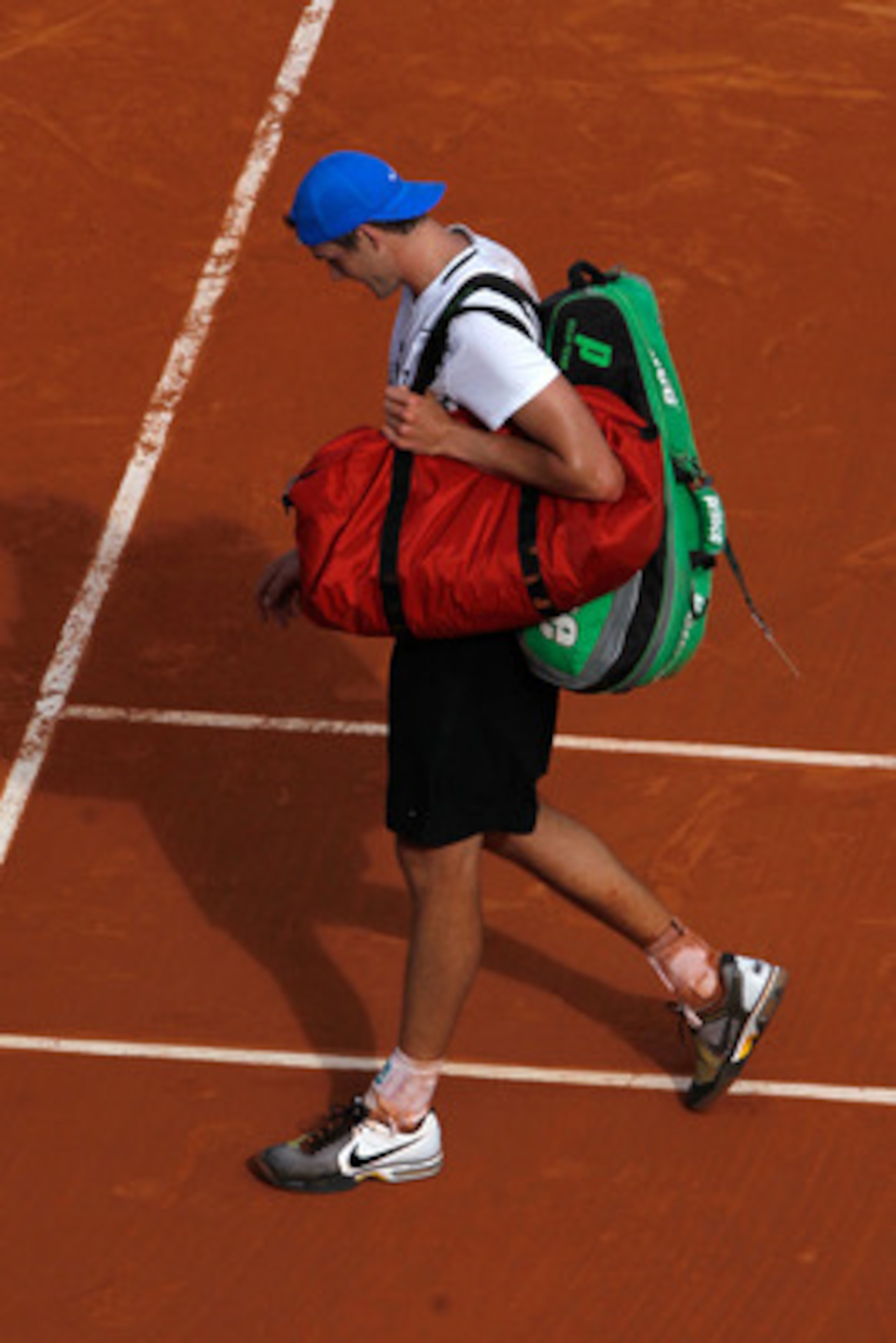 PARIS, FRANCE - MAY 24:  John Isner of USA shows his dejection as he walks off court following the men's singles round one match between Rafael Nadal of Spain and John Isner of USA on day three of the French Open at Roland Garros on May 24, 2011 in Paris,