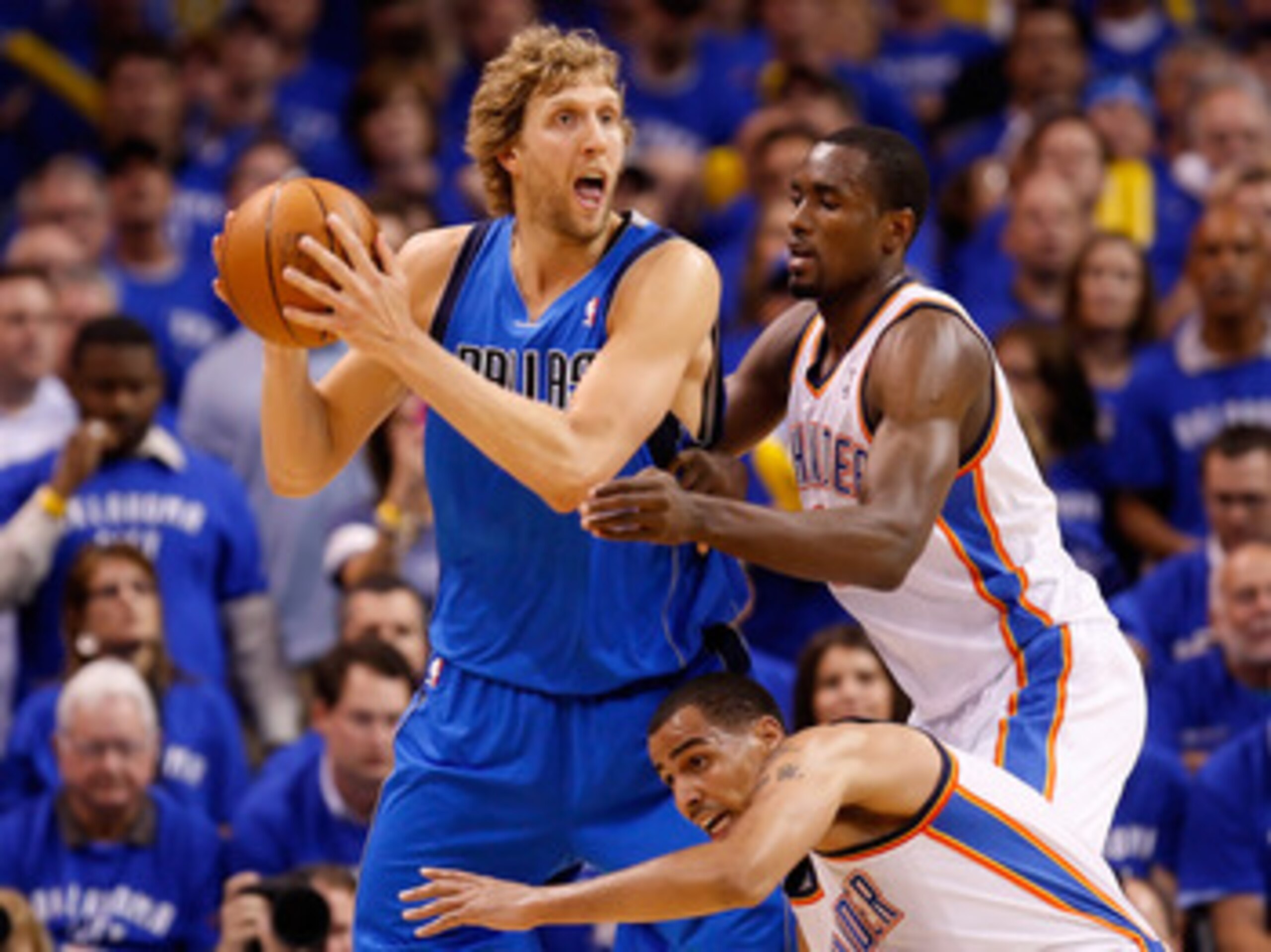 OKLAHOMA CITY, OK - MAY 23:  Dirk Nowitzki #41 of the Dallas Mavericks looks to pass the ball as he is double-teammed by Serge Ibaka #9 and Thabo Sefolosha #2 of the Oklahoma City Thunder in the first half in Game Four of the Western Conference Finals dur