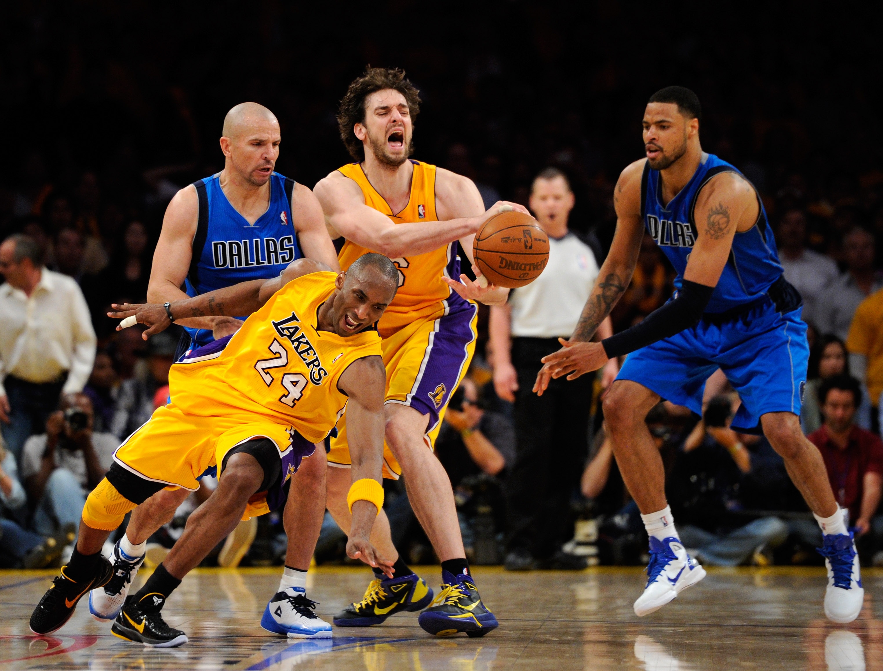 LOS ANGELES, CA - MAY 02:  Kobe Bryant #24 of the Los Angeles Lakers falls down as Pau Gasol #16 looses the ball in front of Jason Kidd #2 and Tyson Chandler #6 of the Dallas Mavericks late in the fourth quarter in Game One of the Western Conference Semif