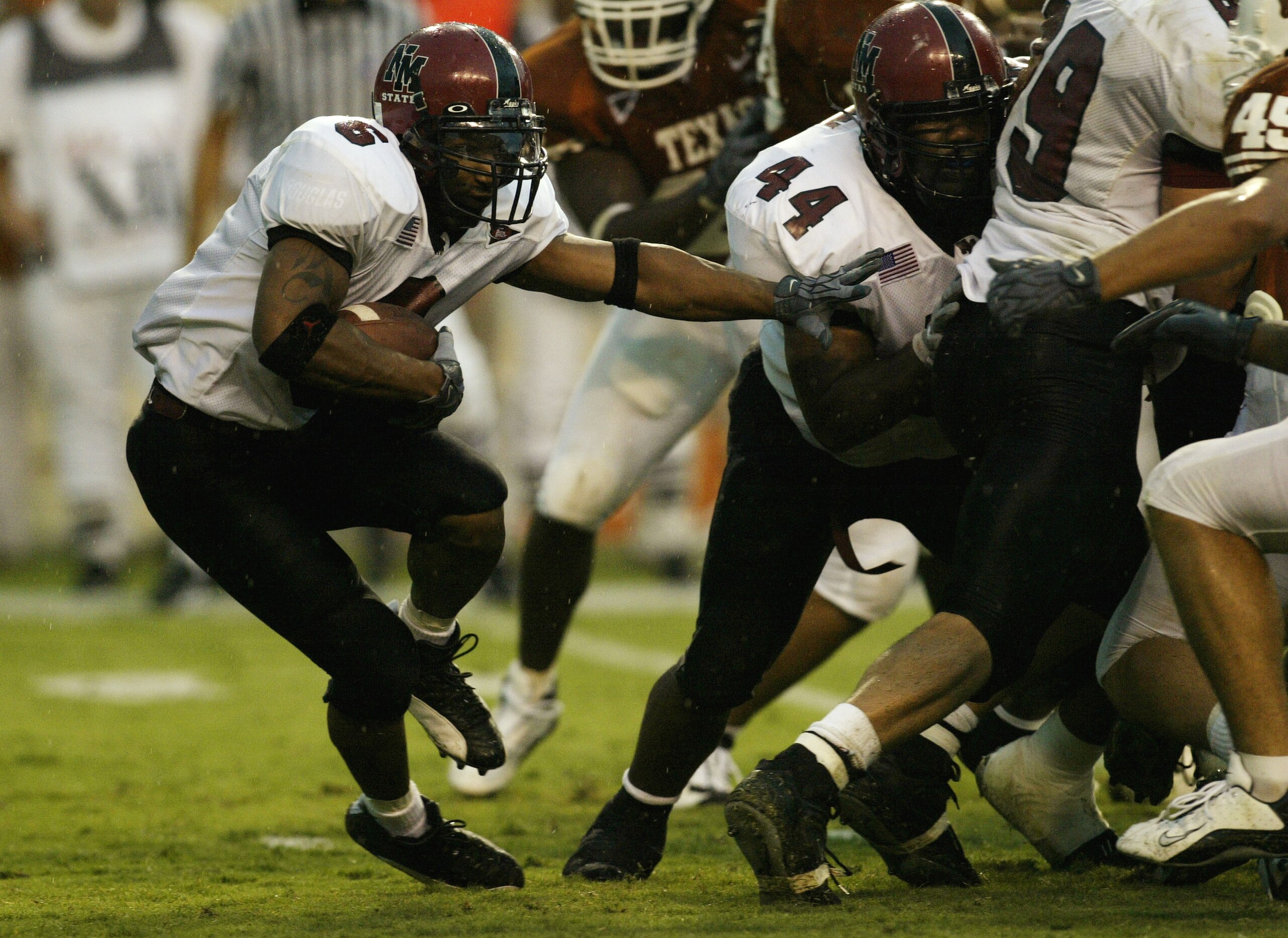 AUSTIN, TX - AUGUST 31:  Running back Keith Mouton #6 of the University of New Mexico Aggies looks for an opening in the University of Texas at Austin Longhorns defense during the game at Texas Memorial Stadium on August 31, 2003 in Austin, Texas. Texas d