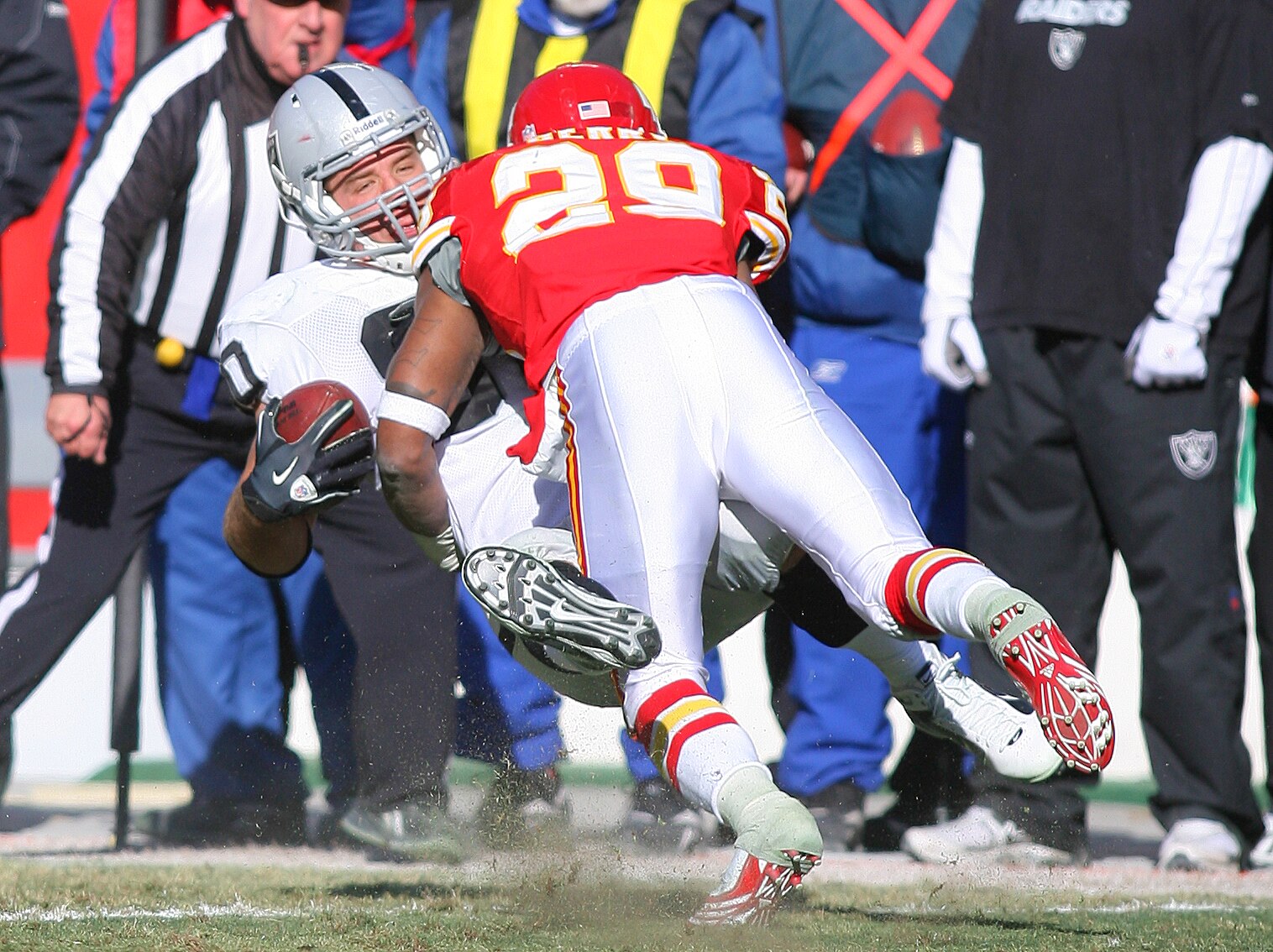 KANSAS CITY, MO - JANUARY 02:  Tight end Zach Miller #80 of the Oakland Raiders is tackled by safety Eric Berry #29 of the Kansas City Chiefs in a game at Arrowhead Stadium on January 2, 2011 in Kansas City, Missouri.  (Photo by Tim Umphrey/Getty Images)