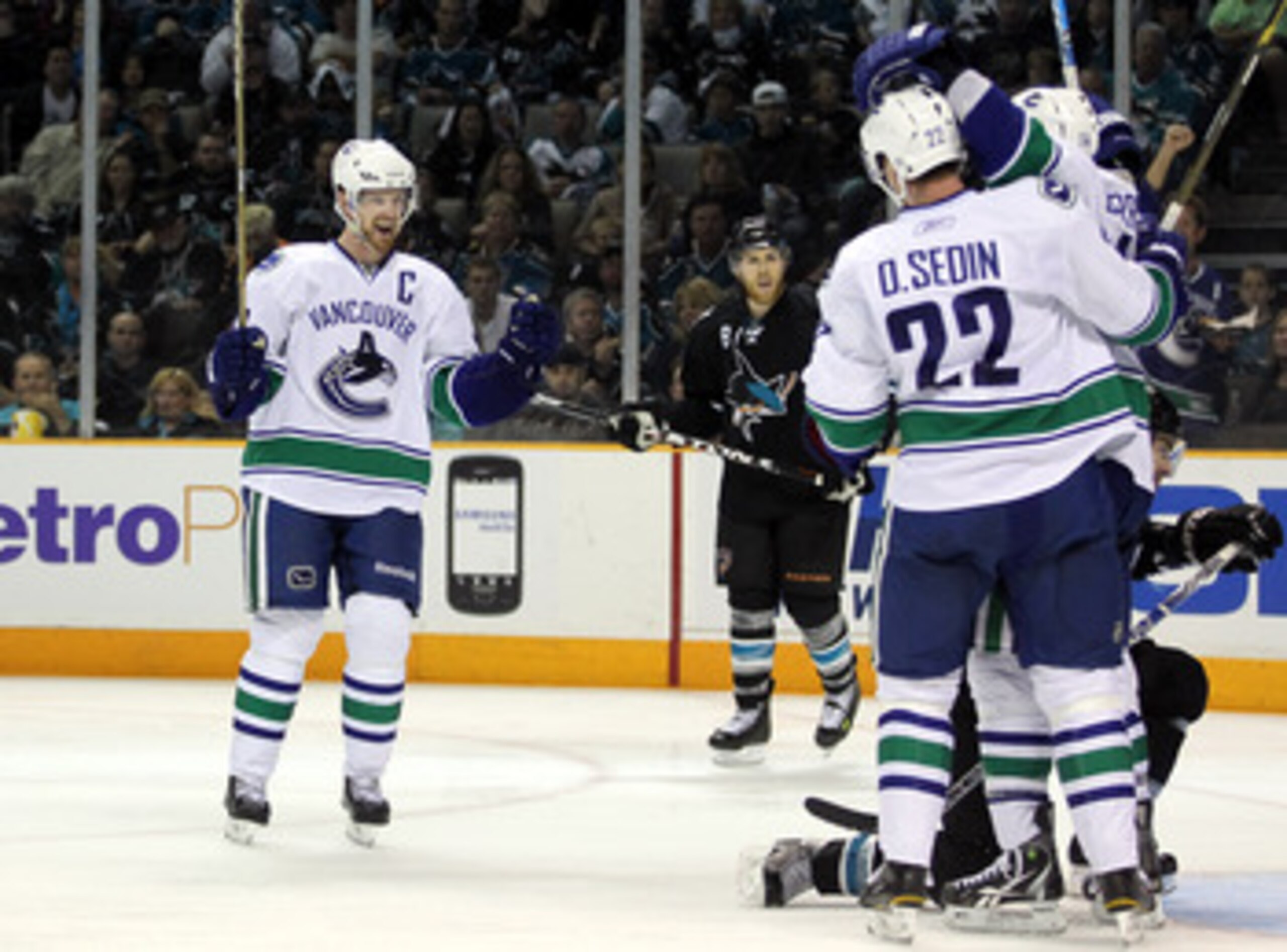 SAN JOSE, CA - MAY 22: Henrik Sedin #33 of the Vancouver Canucks skates in to congratulate teammate Alex Burrows #14 and Daniel Sedin #22 after Burrows scored a goal against the San Jose Sharks in Game Four of the Western Conference Finals during the 201 SAN JOSE, CA - MAY 22: Henrik Sedin #33 of the Vancouver Canucks skates in to congratulate teammate Alex Burrows #14 and Daniel Sedin #22 after Burrows scored a goal against the San Jose Sharks in Game Four of the Western Conference Finals during the 201