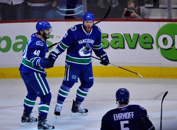 VANCOUVER, CANADA - MAY 18:  Raffi Torres #13 of the Vancouver Canucks reacts after scoring a goal as teammate Maxim Lapierre #40 joins Torres to celebrate in Game Two of the Western Conference Finals against the San Jose Sharks during the 2011 Stanley Cu