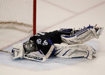 TAMPA, FL - MAY 21:  Dwayne Roloson #35 of the Tampa Bay Lightning falls to the ice in Game Four of the Eastern Conference Finals against the Boston Bruins during the 2011 NHL Stanley Cup Playoffs at St Pete Times Forum on May 21, 2011 in Tampa, Florida. 
