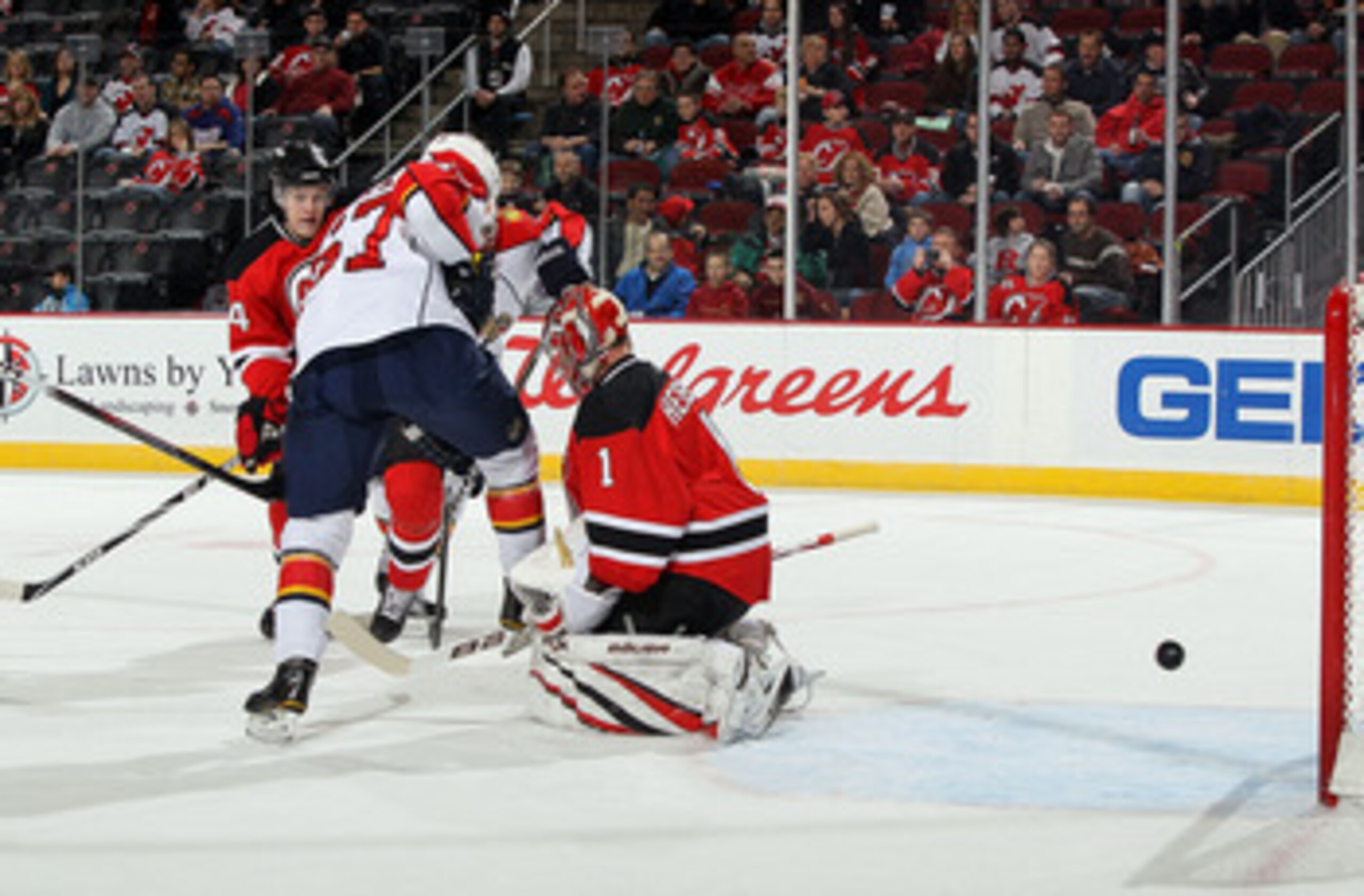 NEWARK, NJ - FEBRUARY 04: Michael Frolik #67 of the Florida Panthers sets up a screen as Johan Hedberg #1 of the New Jersey Devils surrenders a first period goal to Dennis Wideman (not pictured) at the Prudential Center on February 4, 2011 in Newark, New 
