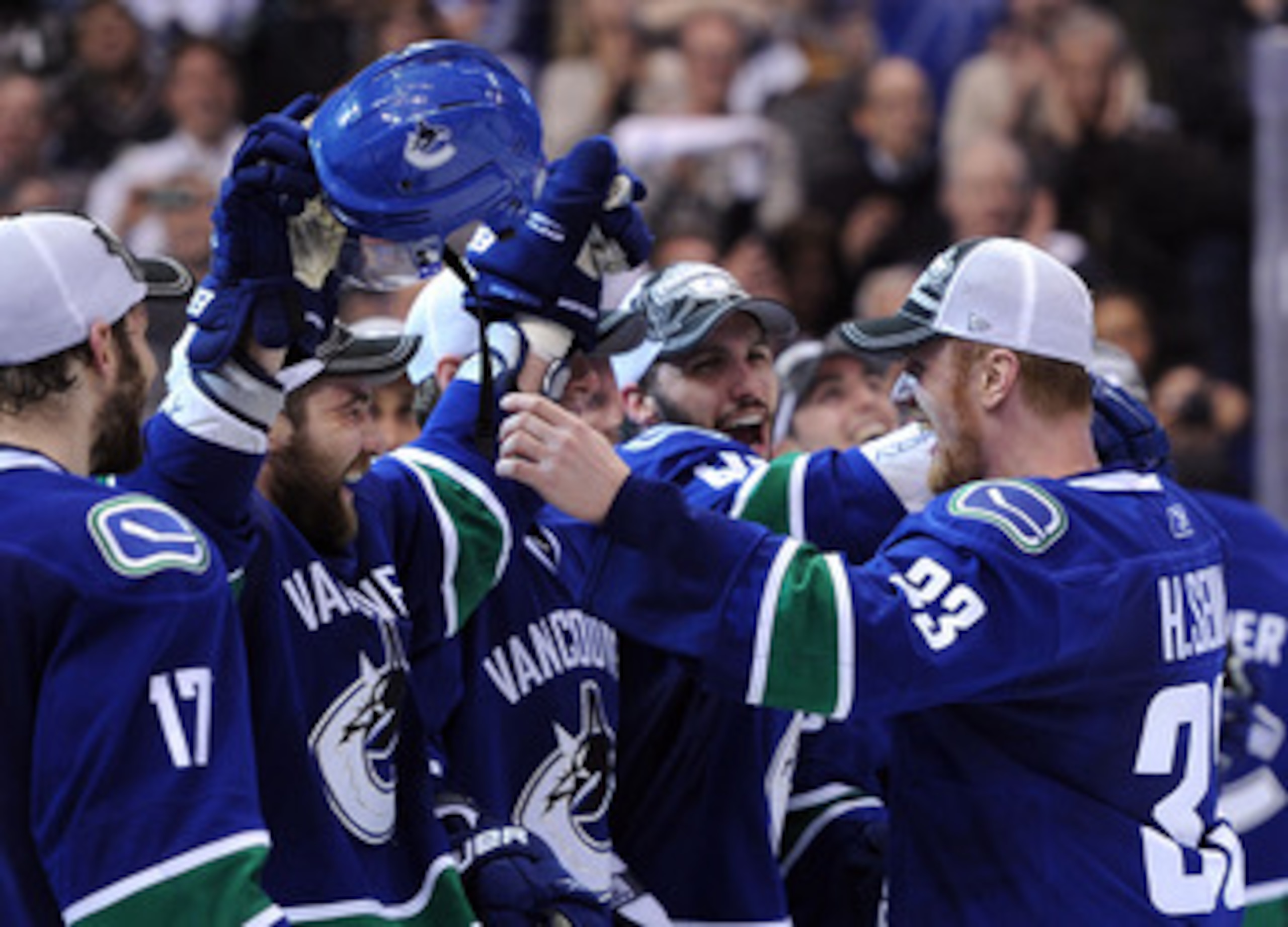 VANCOUVER, BC - MAY 24: Captain Henrik Sedin #33 of the Vancouver Canucks celebrates with teammates Christopher Higgins #20 and Maxim Lapierre #40 after the Vancouver Canucks defeated the San Jose Sharks 3-2 in double-overtime in Game Five to win the Wes VANCOUVER, BC - MAY 24: Captain Henrik Sedin #33 of the Vancouver Canucks celebrates with teammates Christopher Higgins #20 and Maxim Lapierre #40 after the Vancouver Canucks defeated the San Jose Sharks 3-2 in double-overtime in Game Five to win the Wes