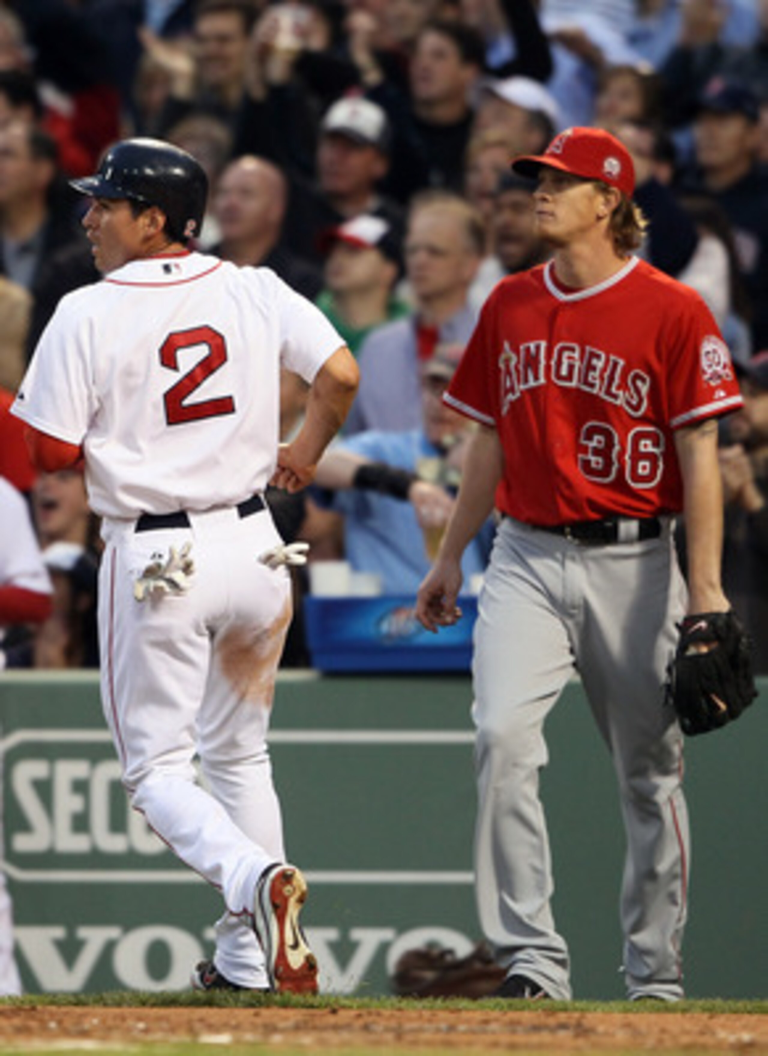 BOSTON, MA - MAY 02:  Jacoby Ellsbury #2 of the Boston Red Sox scores a run as Jered Weaver #36 of the Los Angeles Angels stands behind home plate on May 2, 2011 at Fenway Park in Boston, Massachusetts.  (Photo by Elsa/Getty Images)