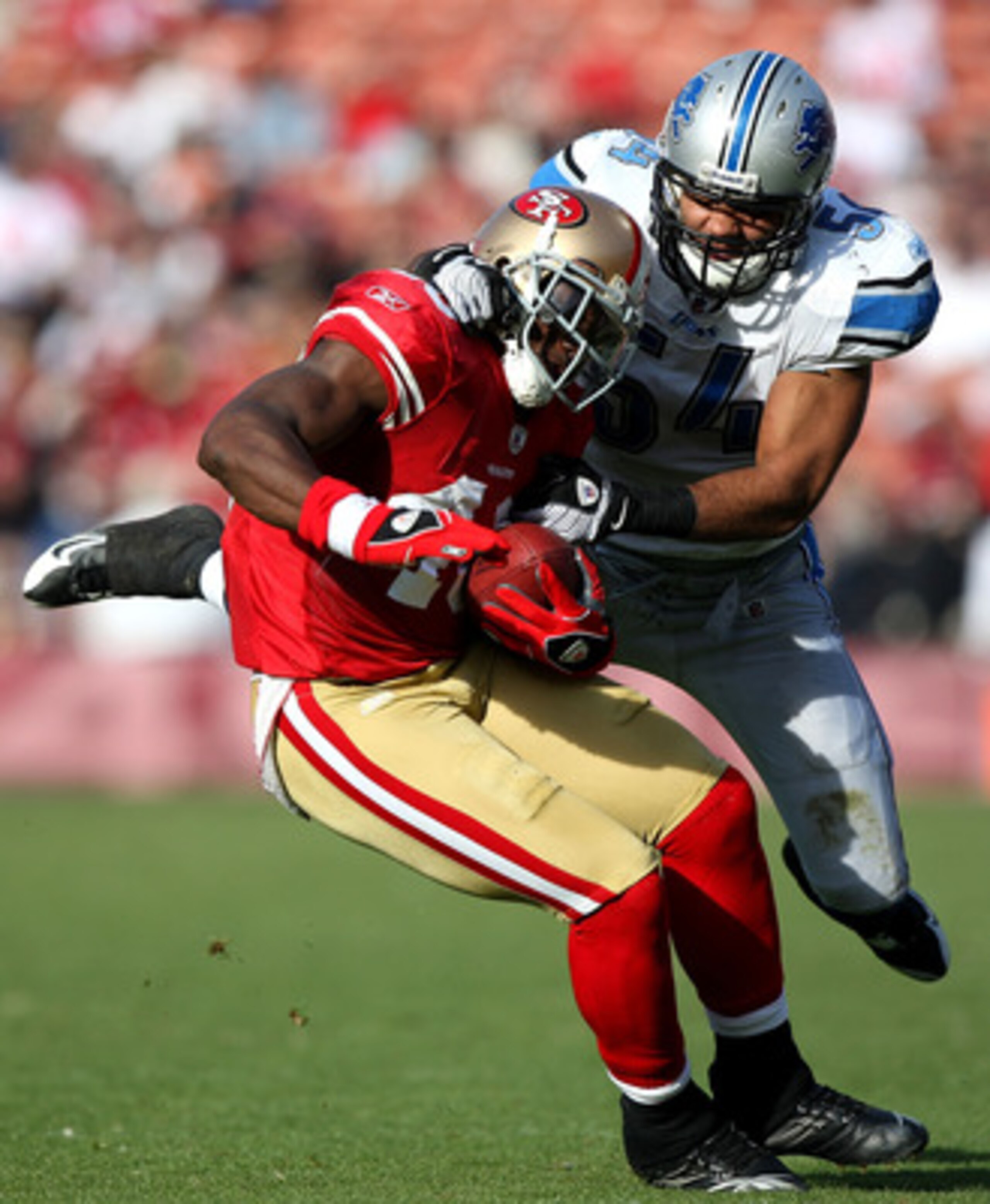 SAN FRANCISCO - DECEMBER 27:  Delanie Walker #46 of the San Francisco 49ers is tackled by DeAndre Levy #54 of the Detroit Lions during an NFL game at Candlestick Park on December 27, 2009 in San Francisco, California.  (Photo by Jed Jacobsohn/Getty Images