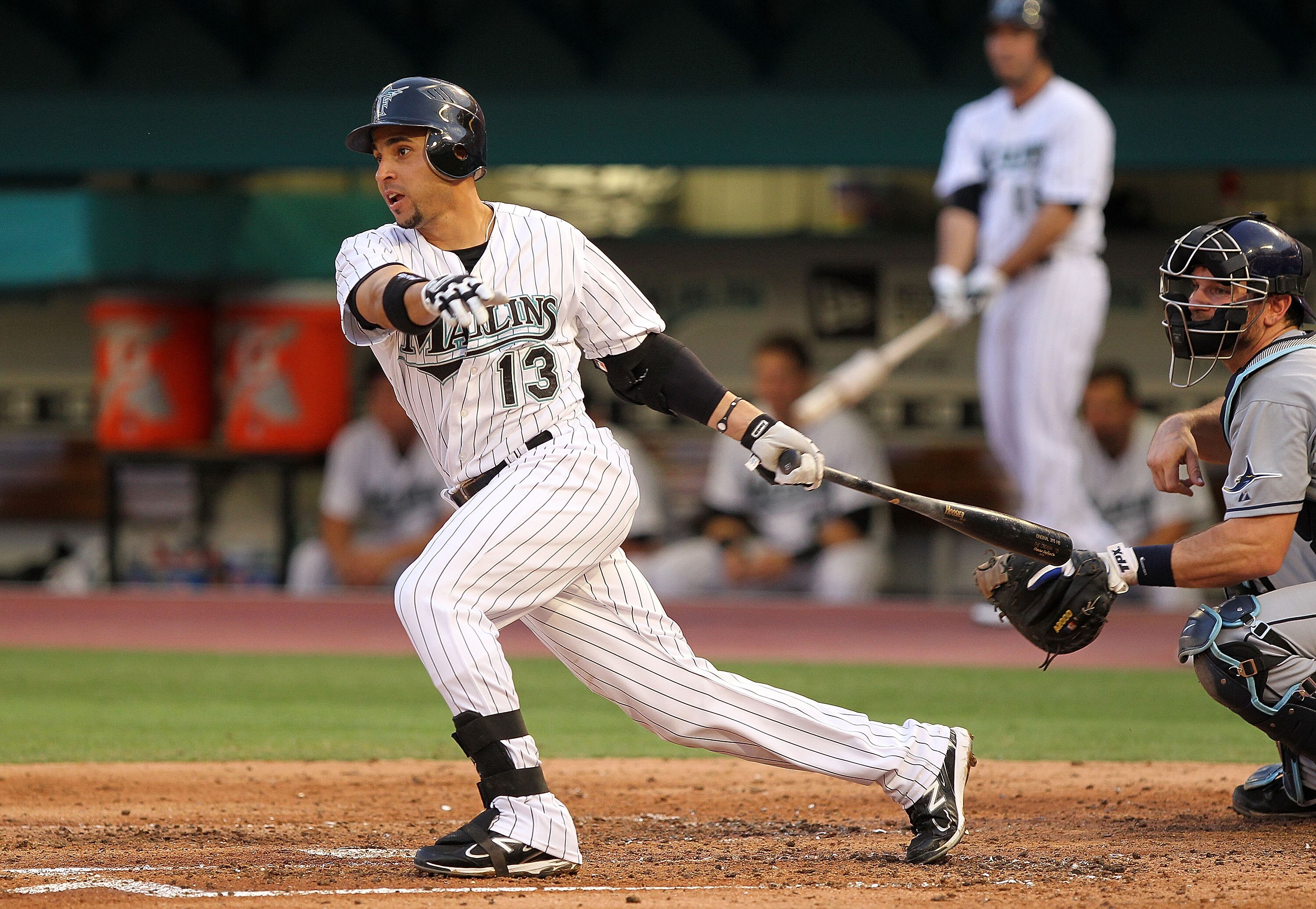 MIAMI GARDENS, FL - MAY 20: Omar Infante #13 of the Florida Marlins hits during a game against the Tampa Bay Rays at Sun Life Stadium on May 20, 2011 in Miami Gardens, Florida. (Photo by Mike Ehrmann/Getty Images)