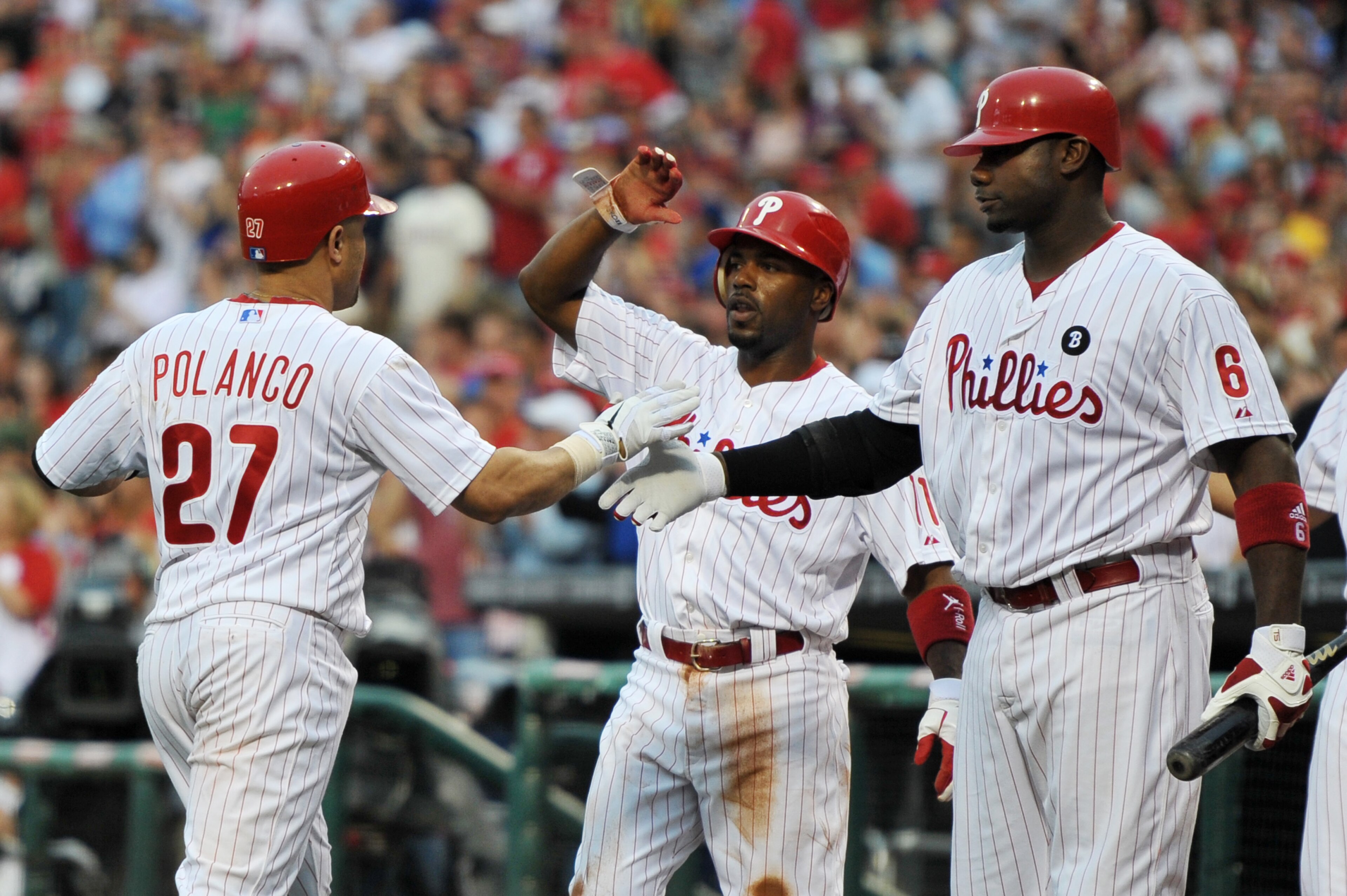 PHILADELPHIA, PA - MAY 23: Placido Polanco #27 of the Philadelphia Phillies gets congratulated by teammates Jimmy Rollins #11 and Ryan Howard #6 after hitting a two run home run during the game against the Cincinnati Reds at Citizens Bank Park on May 23, PHILADELPHIA, PA - MAY 23: Placido Polanco #27 of the Philadelphia Phillies gets congratulated by teammates Jimmy Rollins #11 and Ryan Howard #6 after hitting a two run home run during the game against the Cincinnati Reds at Citizens Bank Park on May 23,