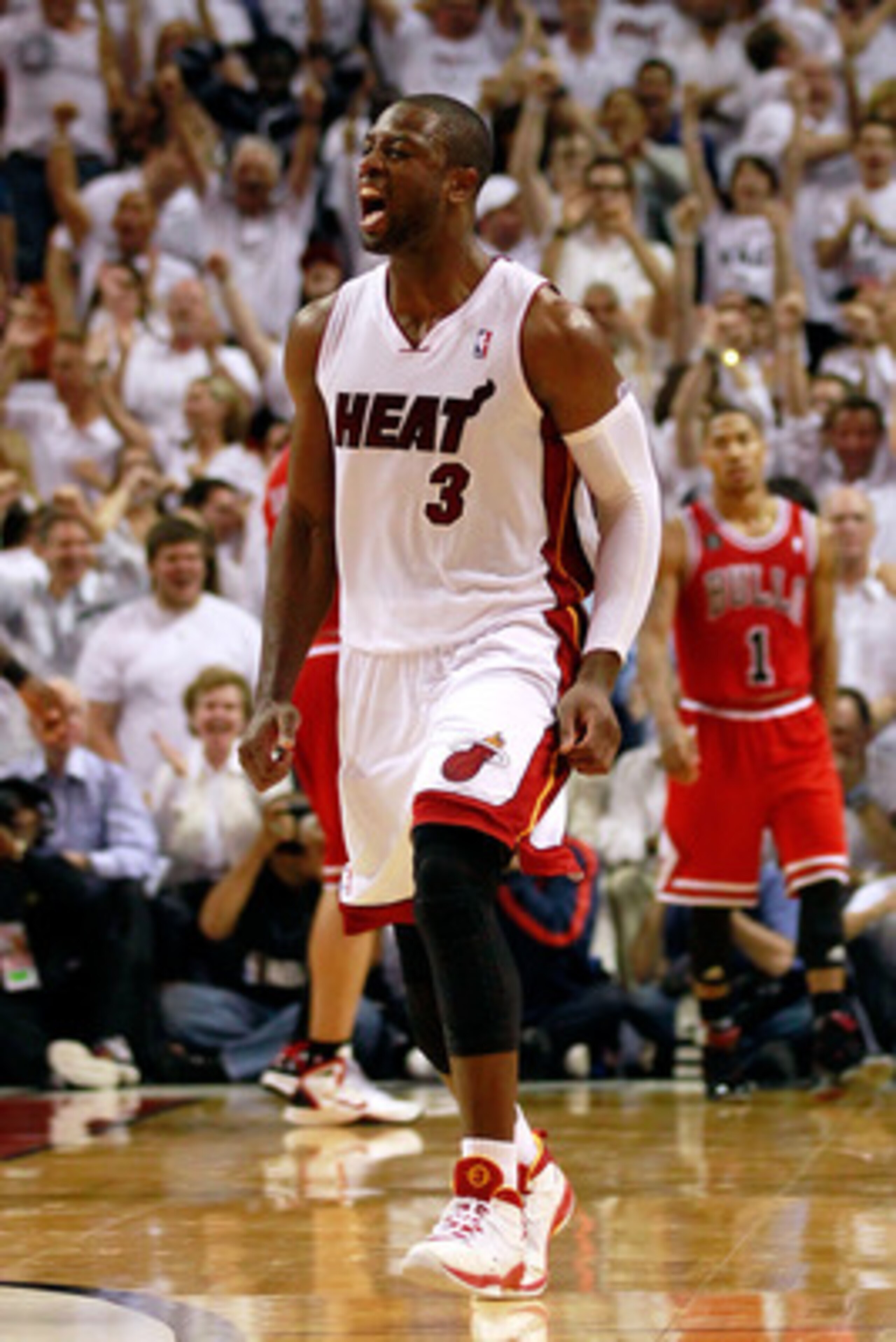 MIAMI, FL - MAY 24:  Dwyane Wade #3 of the Miami Heat celebrates as Derrick Rose #1 of the Chicago Bulls looks on dejected in Game Four of the Eastern Conference Finals during the 2011 NBA Playoffs on May 24, 2011 at American Airlines Arena in Miami, Flor
