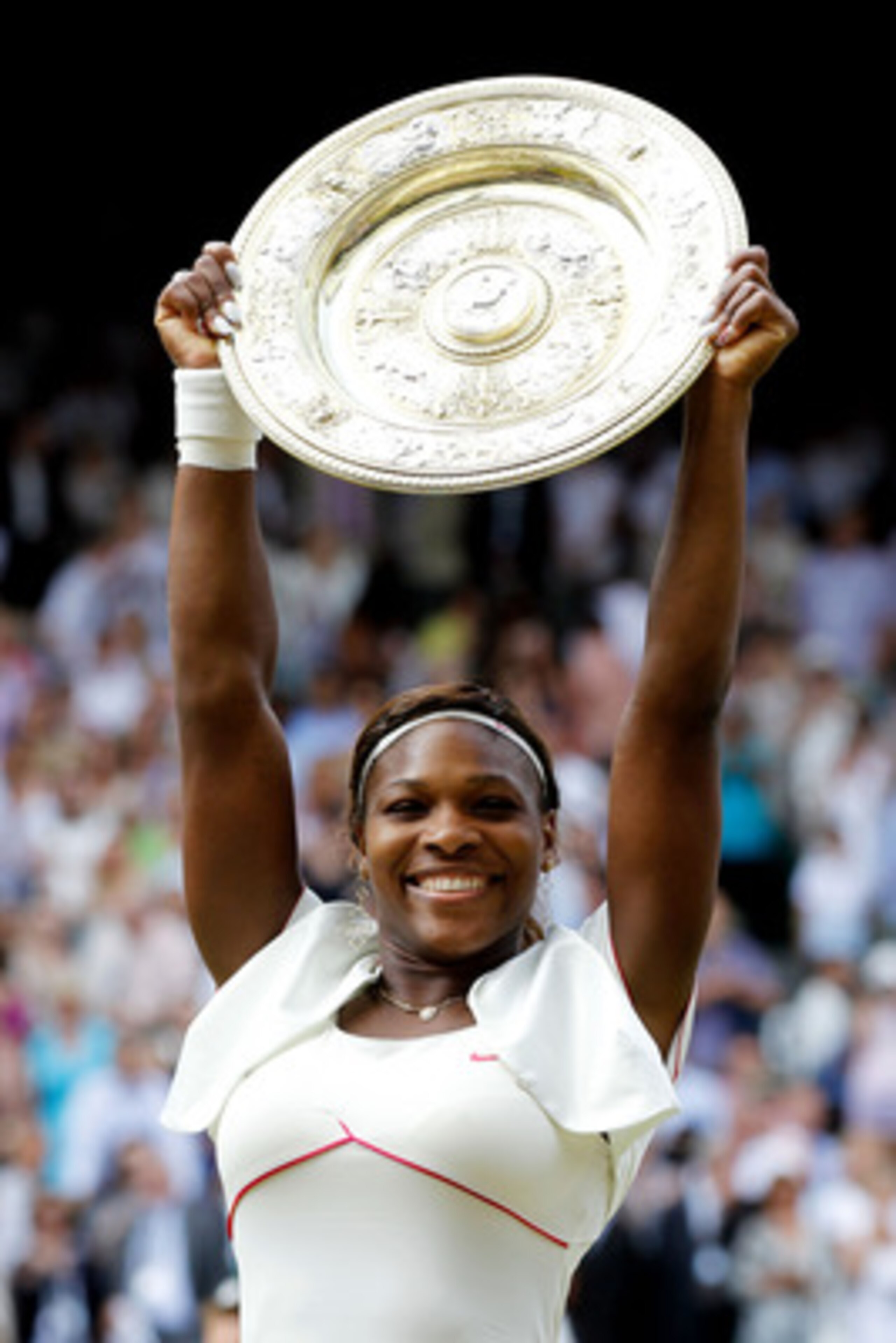 LONDON, ENGLAND - JULY 03:  Serena Williams of USA lifts the Championship trophy after winning her Ladies Singles Final Match against Vera Zvonareva of Russia on Day Twelve of the Wimbledon Lawn Tennis Championships at the All England Lawn Tennis and Croq