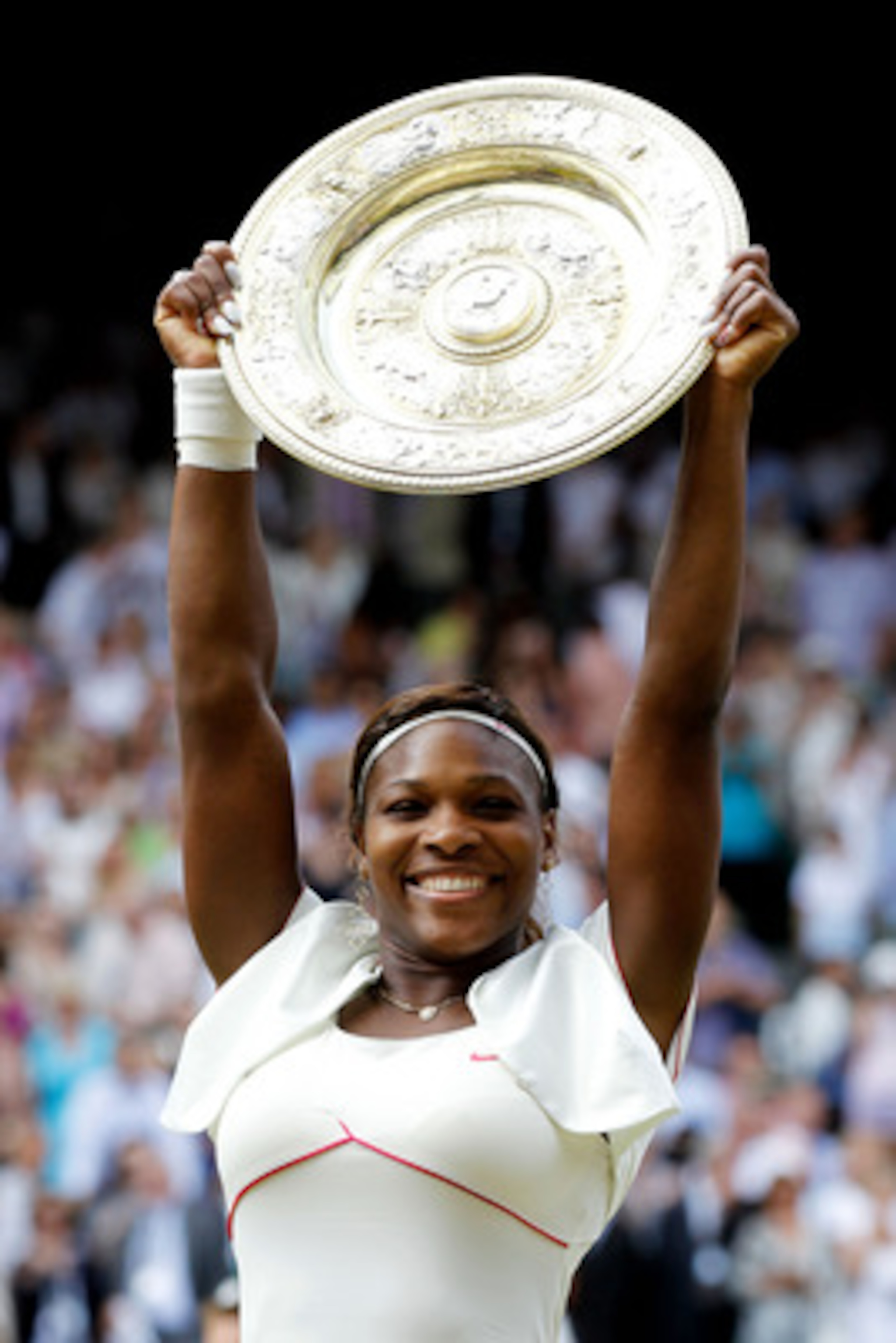LONDON, ENGLAND - JULY 03:  Serena Williams of USA lifts the Championship trophy after winning her Ladies Singles Final Match against Vera Zvonareva of Russia on Day Twelve of the Wimbledon Lawn Tennis Championships at the All England Lawn Tennis and Croq