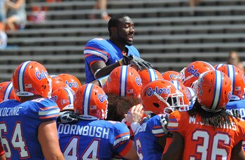 GAINESVILLE, FL - APRIL 9:  Running back Chris Rainey #3 of the Florida Gators climbs to the top of a team huddle before the Orange and Blue spring football game April 9, 2011 at Ben Hill Griffin Stadium in Gainesville, Florida.  (Photo by Al Messerschmid
