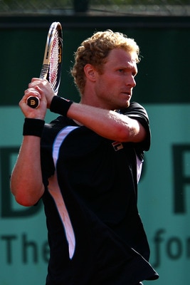 PARIS, FRANCE - MAY 24:  Dmitry Tursunov of Russia hits a backhand during the men's singles round one match between Dmitry Tursunov of Russia and Xavier Malisse of Belgium on day three of the French Open at Roland Garros on May 24, 2011 in Paris, France.