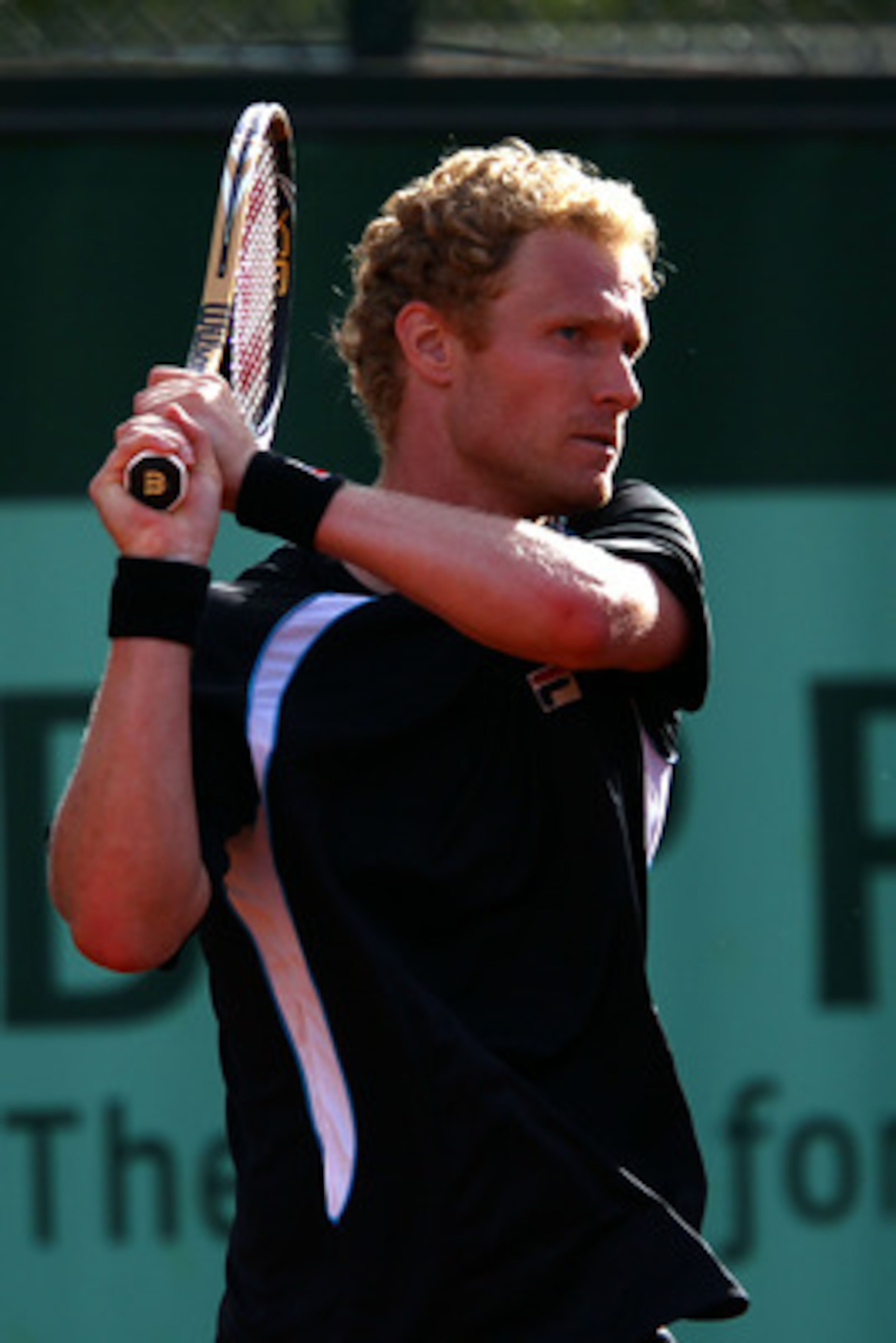 PARIS, FRANCE - MAY 24:  Dmitry Tursunov of Russia hits a backhand during the men's singles round one match between Dmitry Tursunov of Russia and Xavier Malisse of Belgium on day three of the French Open at Roland Garros on May 24, 2011 in Paris, France.