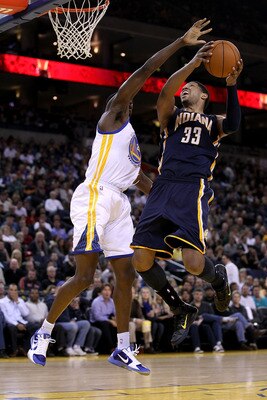 OAKLAND, CA - JANUARY 19:  Danny Granger #33 of the Indiana Pacers goes up for a shot on Ekpe Udoh #20 of the Golden State Warriors at Oracle Arena on January 19, 2011 in Oakland, California.  NOTE TO USER: User expressly acknowledges and agrees that, by
