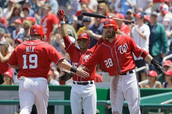 WASHINGTON, DC - MAY 15: Laynce Nix #19 of the Washington Nationals celebrates after scoring against the Florida Marlins with teammates Jayson Werth #28 and Jerry Hairston #15 (C) during the first inning at Nationals Park on May 15, 2011 in Washington, DC