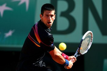 PARIS, FRANCE - MAY 25:  Novak Djokovic of Serbia hits a backhand during the men's singles round two match between Victor Hanescu of Romania and Novak Djokovic of Serbia on day four of the French Open at Roland Garros on May 25, 2011 in Paris, France.  (P