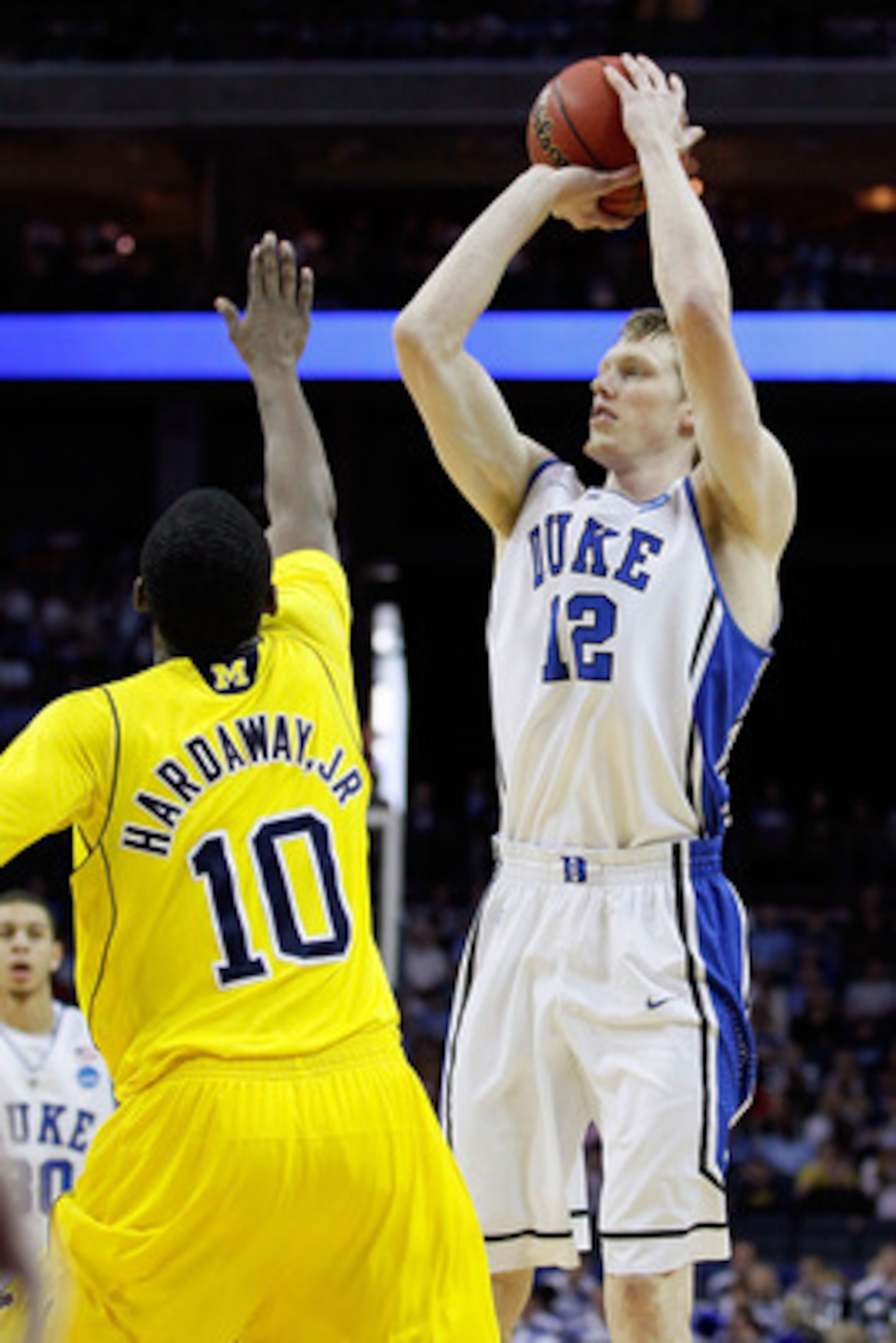 CHARLOTTE, NC - MARCH 20:  Kyle Singler #12 of the Duke Blue Devils shoots over Tim Hardaway Jr. #10 of the Michigan Wolverines during the third round of the 2011 NCAA men's basketball tournament at Time Warner Cable Arena on March 20, 2011 in Charlotte, 