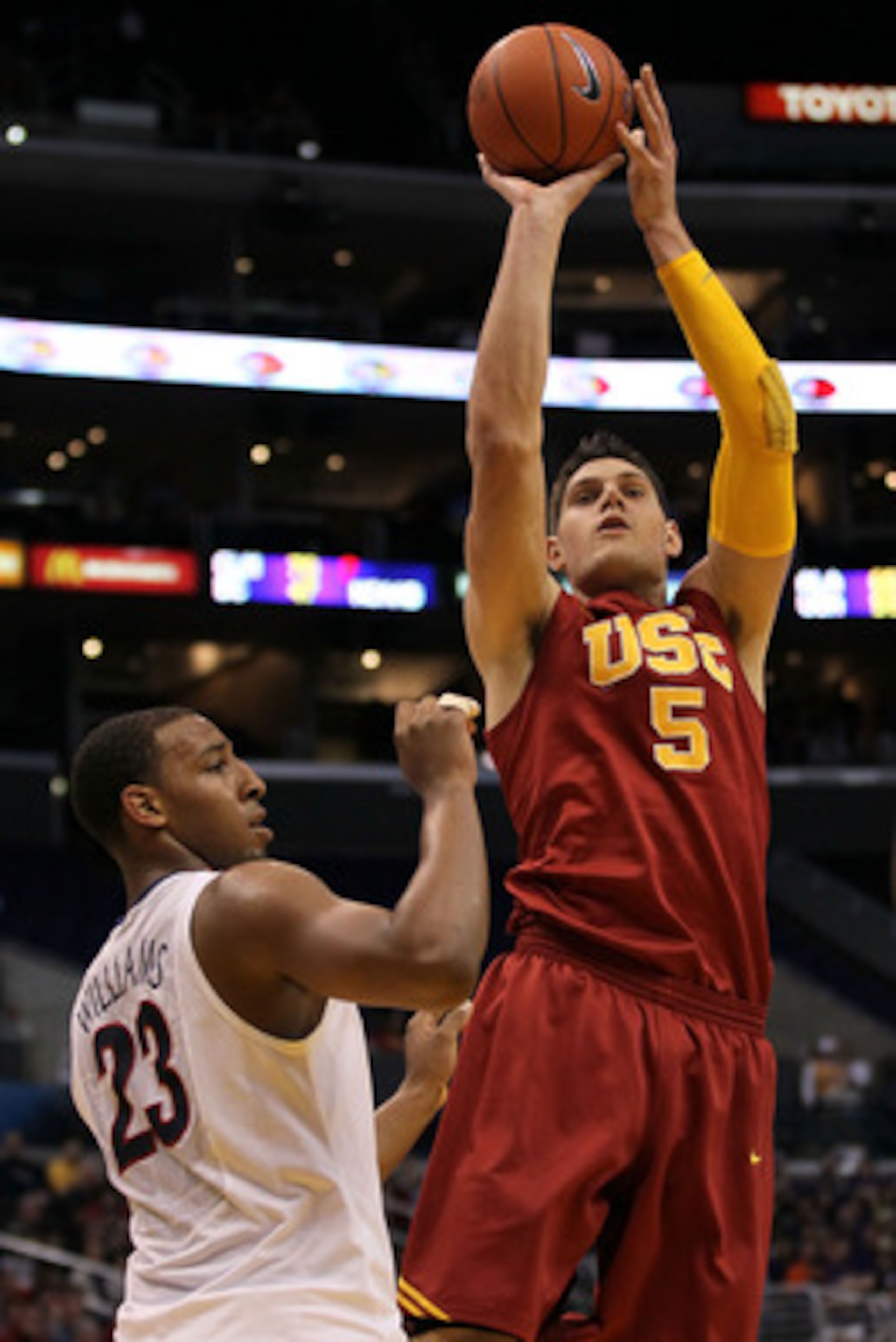 LOS ANGELES, CA - MARCH 11:  Nikola Vucevic #5 of the USC Trojans shoots over Derrick Williams #23 of the Arizona Wildcats in the first half in the semifinals of the 2011 Pacific Life Pac-10 Men's Basketball Tournament at Staples Center on March 11, 2011