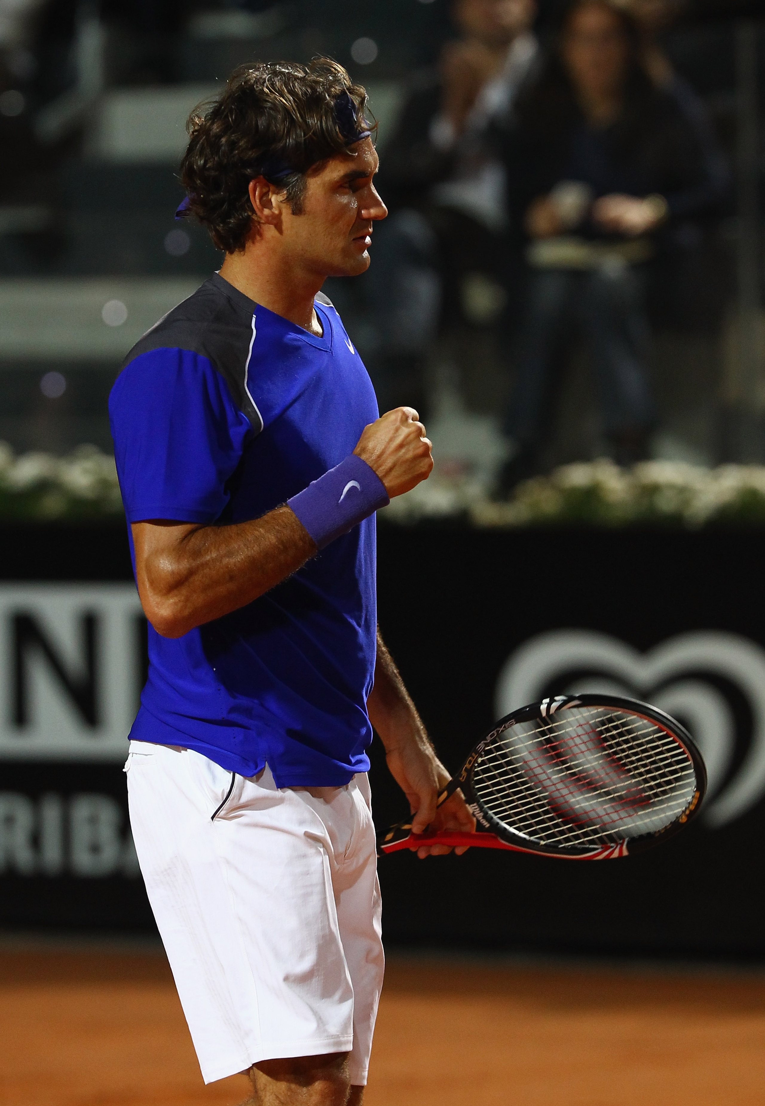 ROME, ITALY - MAY 11:  Roger Federer of Switzerland celebrates match point during his second round match against Jo-Wilfried Tsonga of France during day four of the Internazoinali BNL D'Italia at the Foro Italico Tennis Centre on May 11, 2011 in Rome, Ita