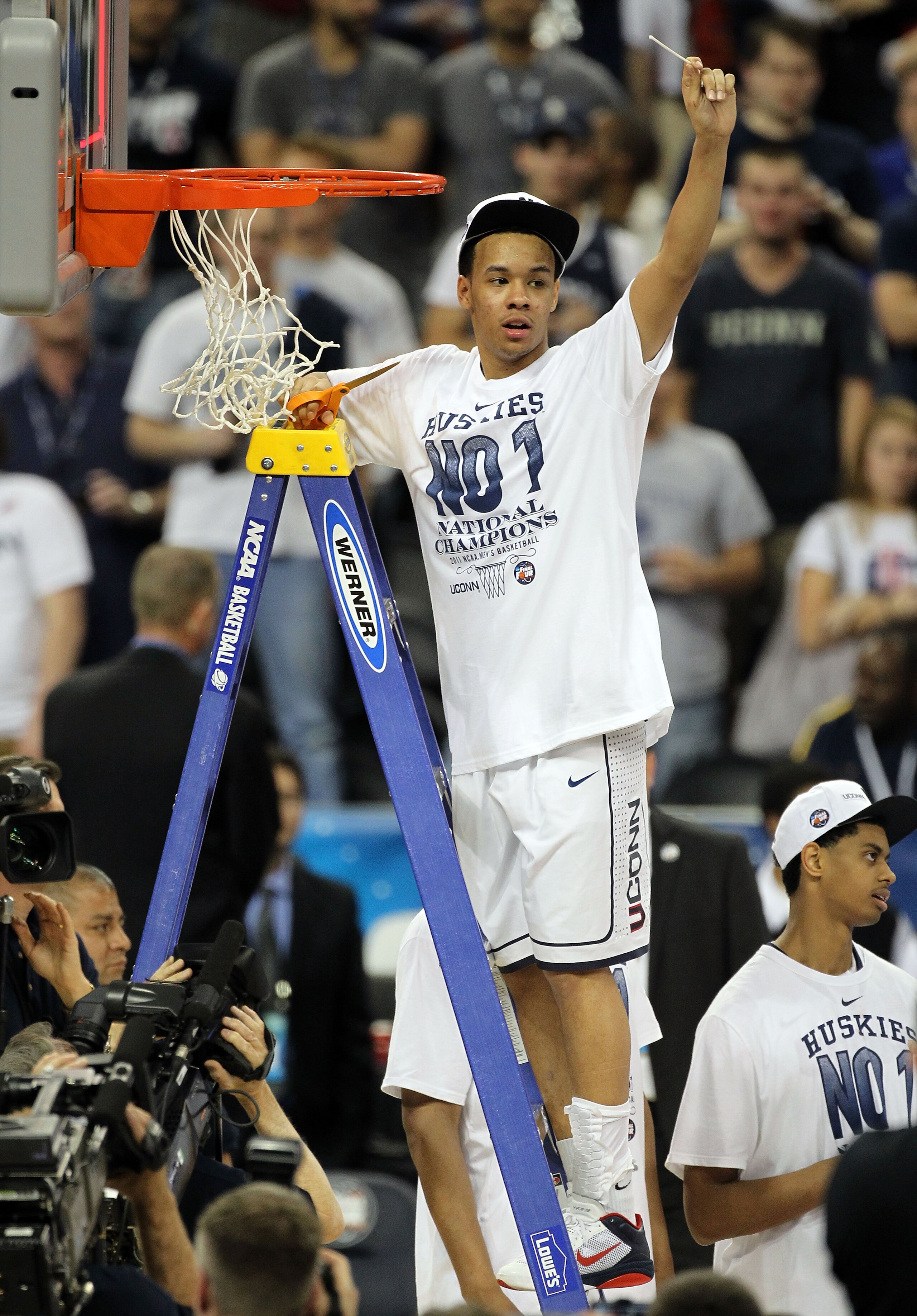 HOUSTON, TX - APRIL 04: Shabazz Napier #13 of the Connecticut Huskies cuts down the net after defeating the Butler Bulldogs to win the National Championship Game of the 2011 NCAA Division I Men's Basketball Tournament by a score of 53-41 at Reliant Stadi HOUSTON, TX - APRIL 04: Shabazz Napier #13 of the Connecticut Huskies cuts down the net after defeating the Butler Bulldogs to win the National Championship Game of the 2011 NCAA Division I Men's Basketball Tournament by a score of 53-41 at Reliant Stadi