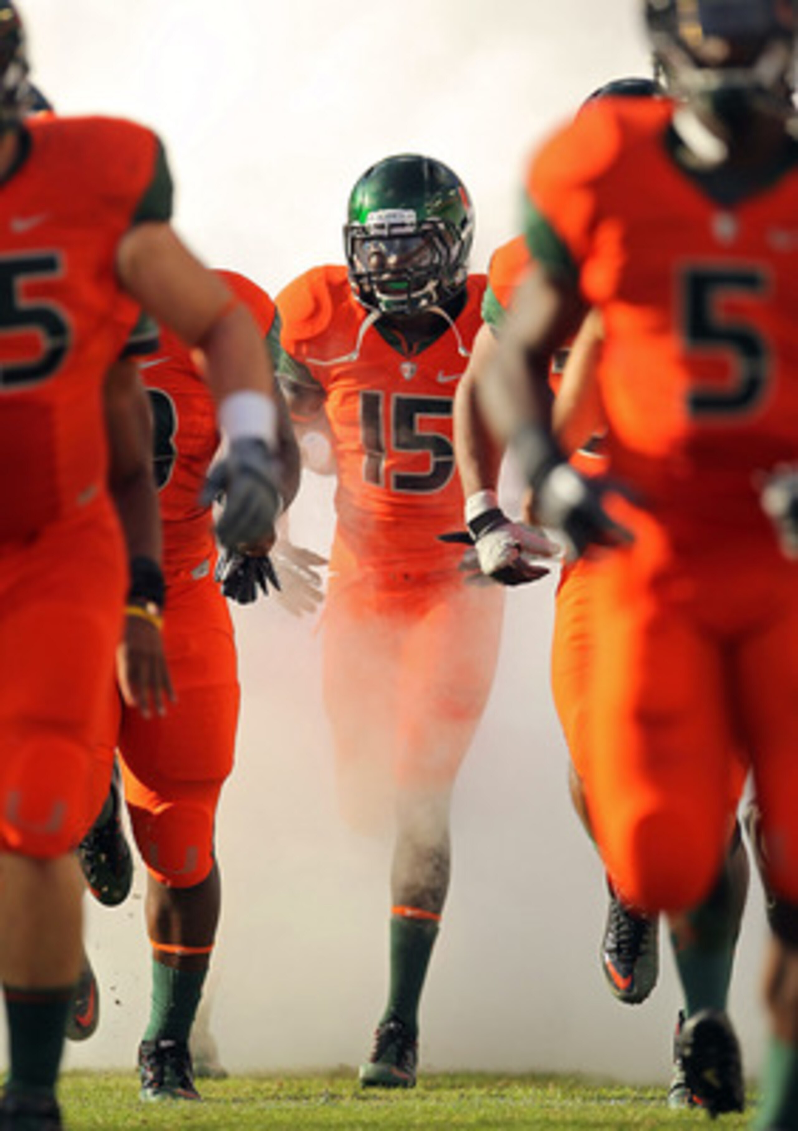 MIAMI - NOVEMBER 20: Jamal Reid #15 of the Miami Hurricanes runs out of the tunnel during a game against the Virginia Tech Hokies at Sun Life Stadium on November 20, 2010 in Miami, Florida.  (Photo by Mike Ehrmann/Getty Images)
