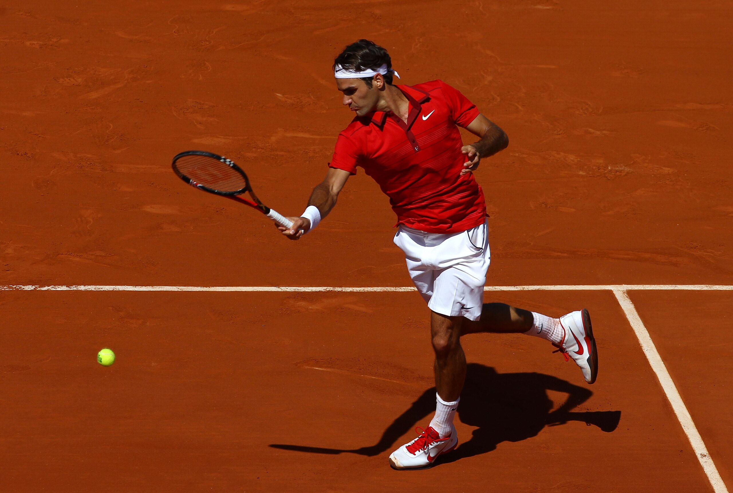 PARIS, FRANCE - MAY 23:  Roger Federer of Switzerland plays a forehand during the men's singles first round match between Feliciano Lopez of Spain and Roger Federer of Switzerland on day two of the French Open at Roland Garros on May 23, 2011 in Paris, Fr