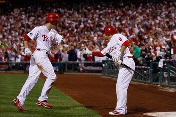 PHILADELPHIA - OCTOBER 23:  Chase Utley #26 of the Philadelphia Phillies is congratulated by Shane Victorino #8 after scoring on a first inning sacrifice fly by Jayson Werth against the San Francisco Giants in Game Six of the NLCS during the 2010 MLB Play